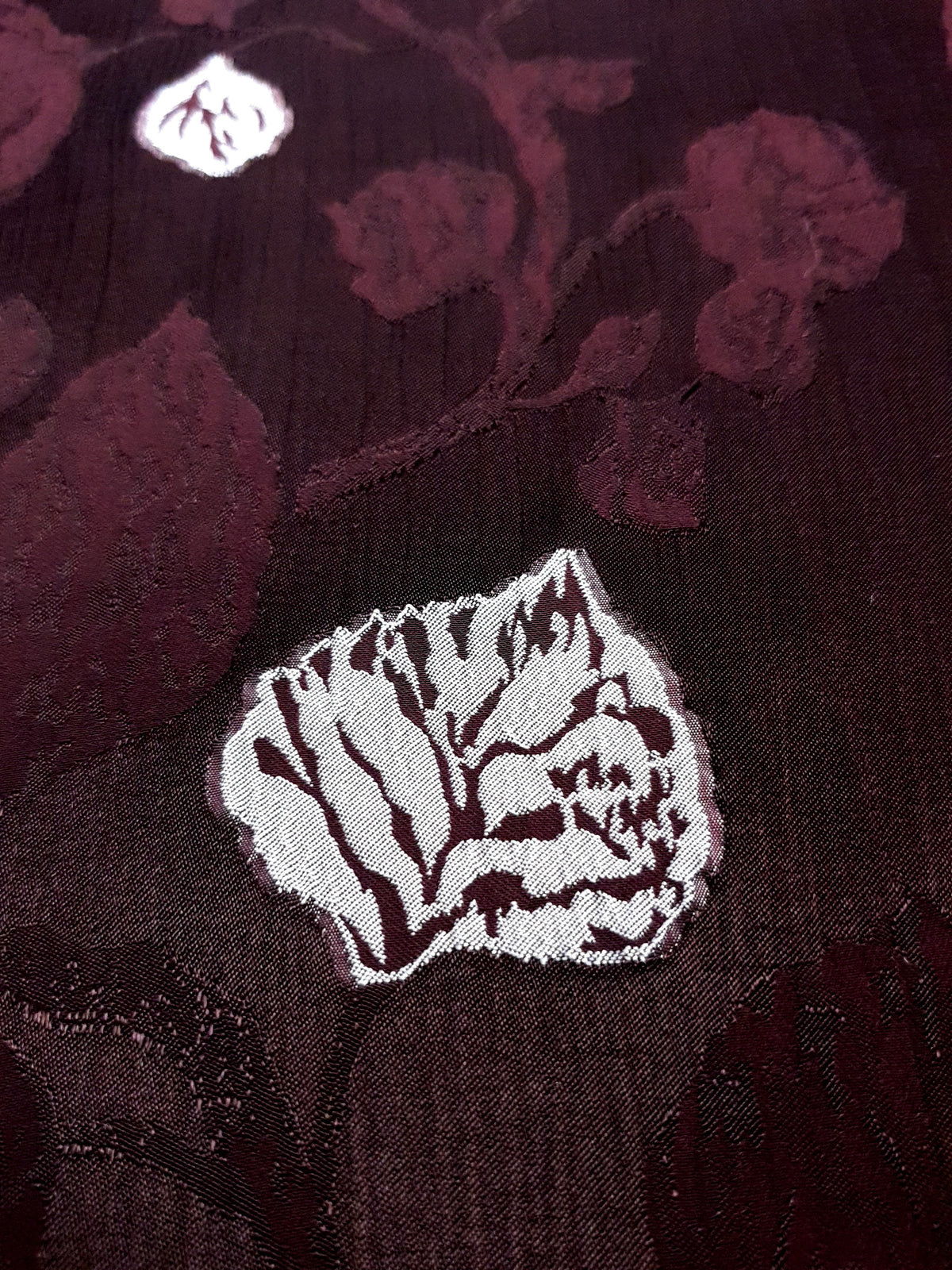 Close detail of embossed two-tone viscose jacquard showing raised woven texture and color depth.