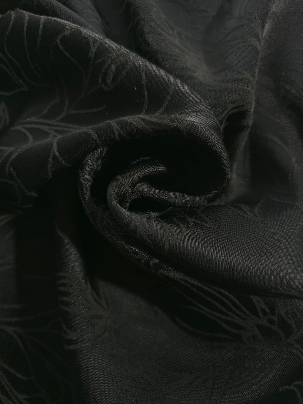Tonal silky viscose jacquard draped to show fluid movement relevant to garment construction and sewing.