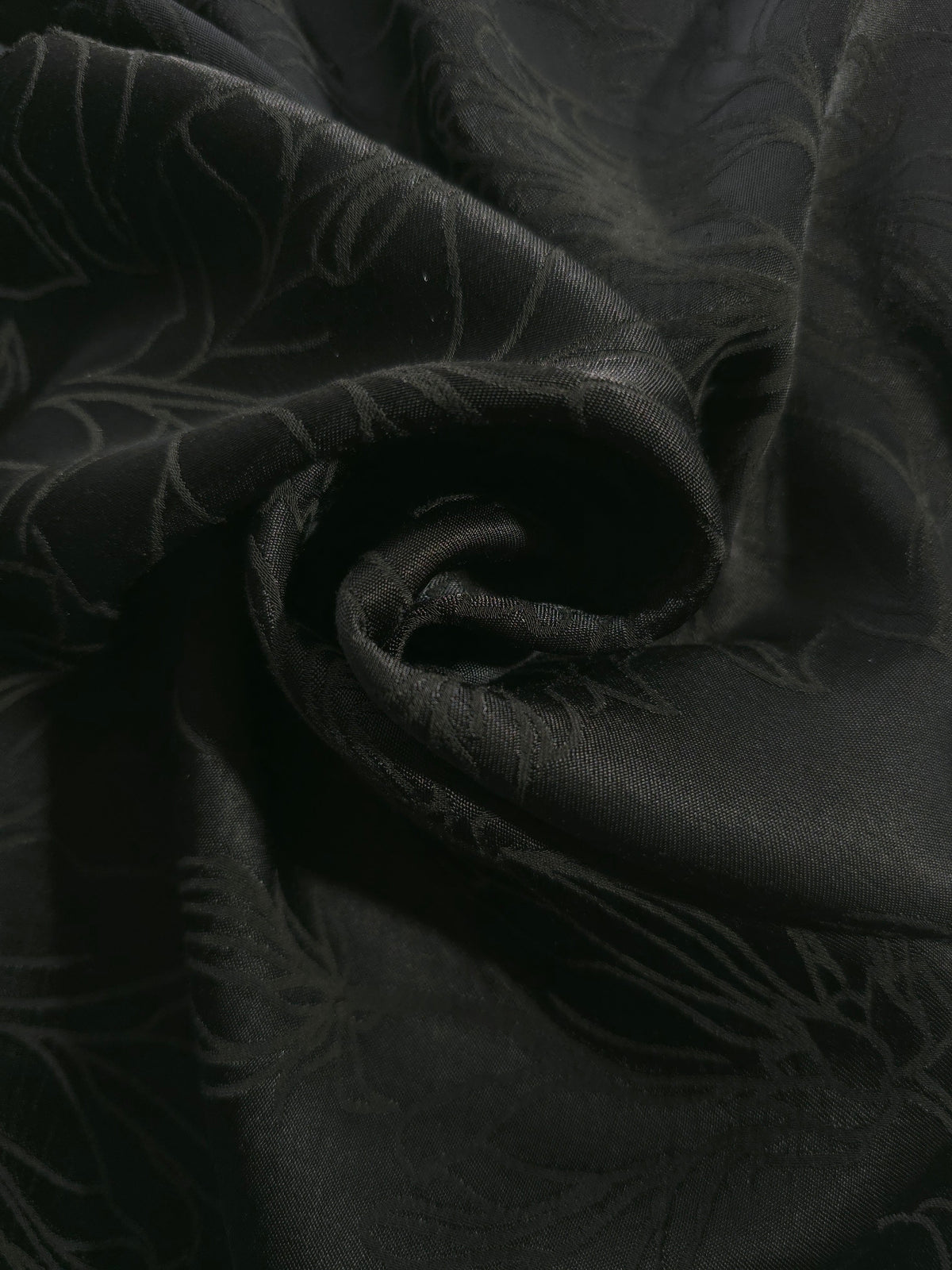 Tonal silky viscose jacquard draped to show fluid movement relevant to garment construction and sewing.