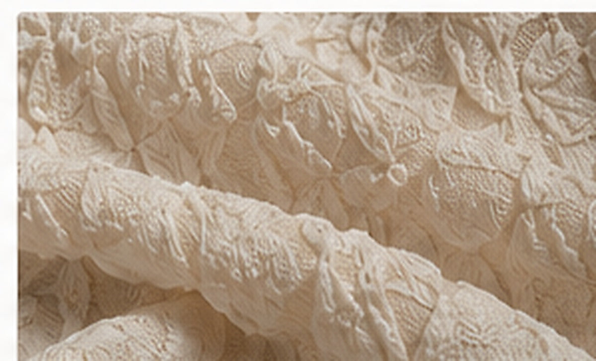 Textured cloque and crinkled ivory fabric for HIBA Fabrics editorial coverage of tactile fashion trends in 2026.