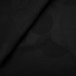 Close-up of black botanical leaf print on soft 100% viscose fabric