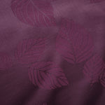 Close-up of cherry burgundy botanical leaf print viscose fabric