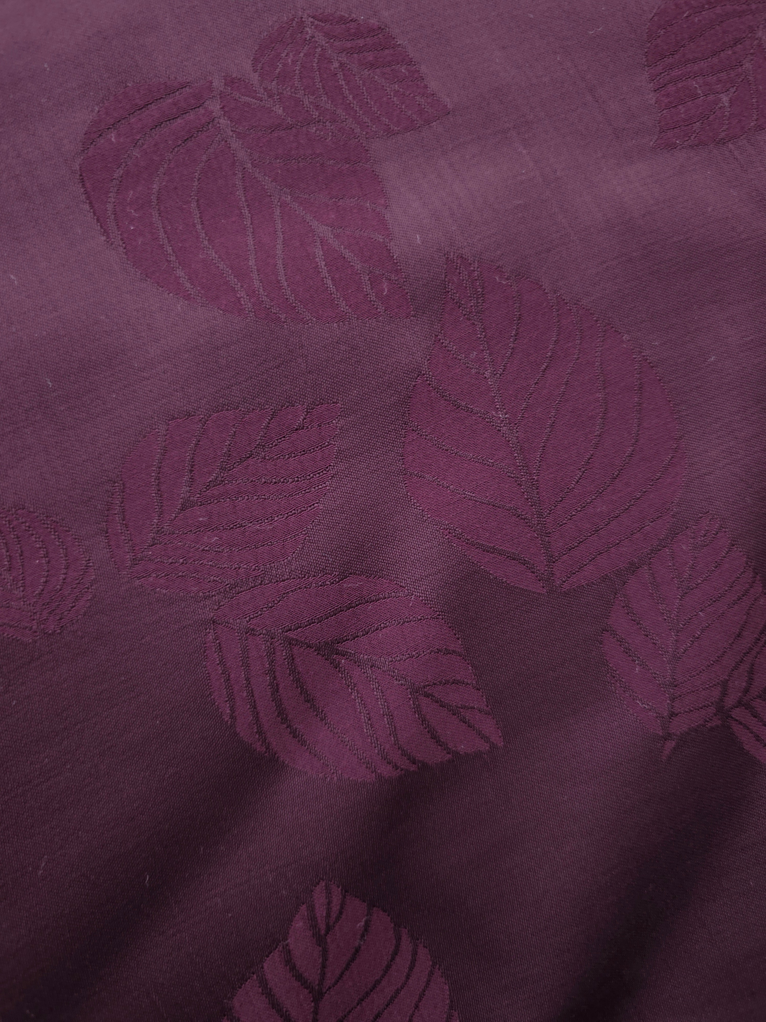 Close-up of cherry burgundy botanical leaf print viscose fabric