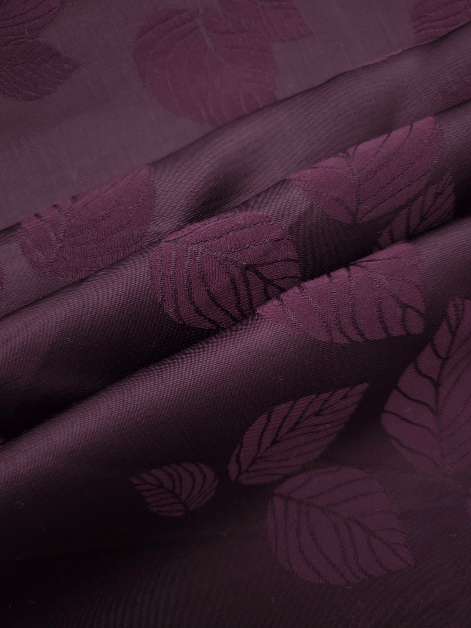 Cherry burgundy botanical leaf print fabric detail showing organic pattern