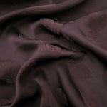 Warm beige botanical leaf print viscose fabric with flowing drape