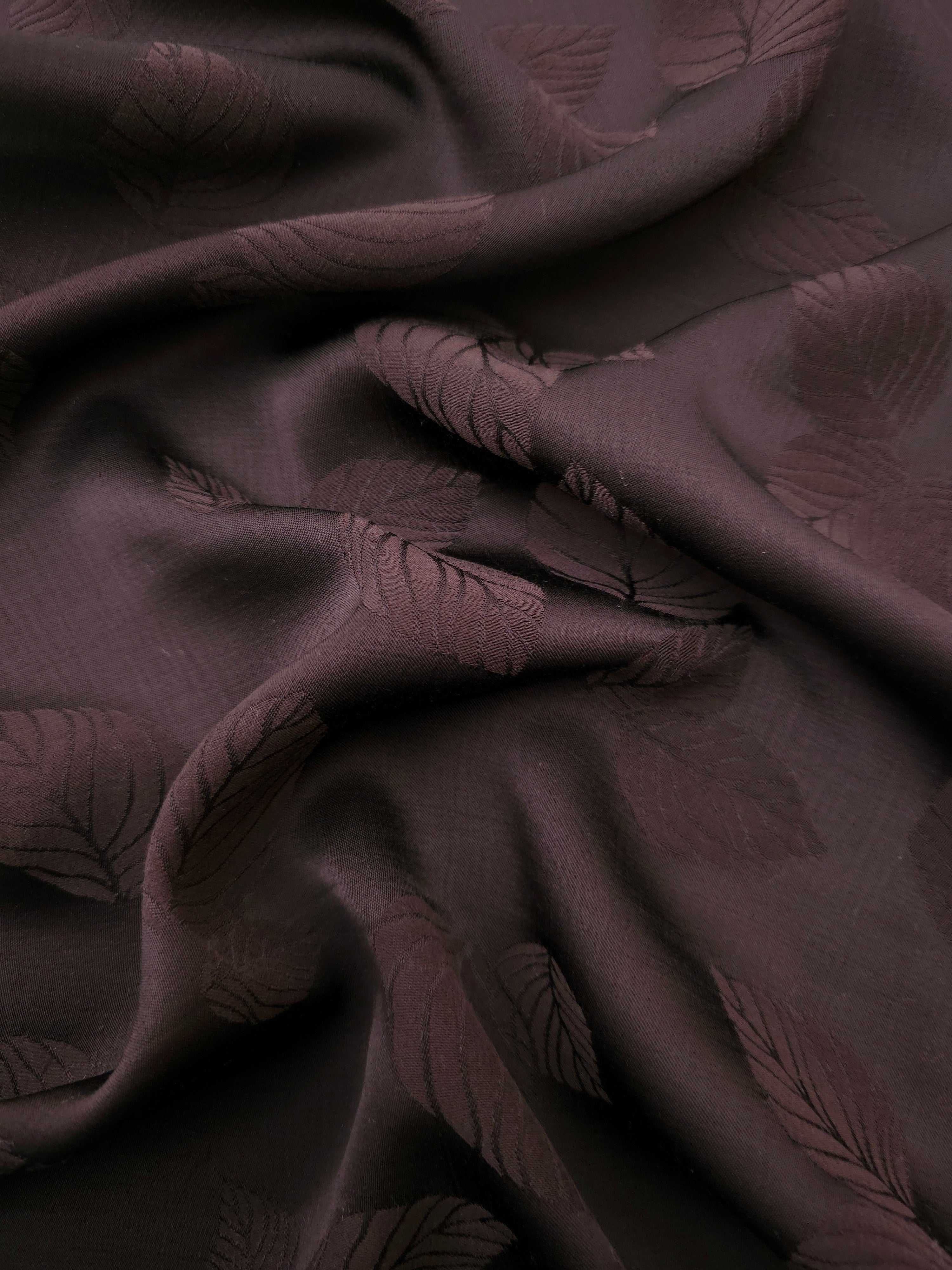 Warm beige botanical leaf print viscose fabric with flowing drape