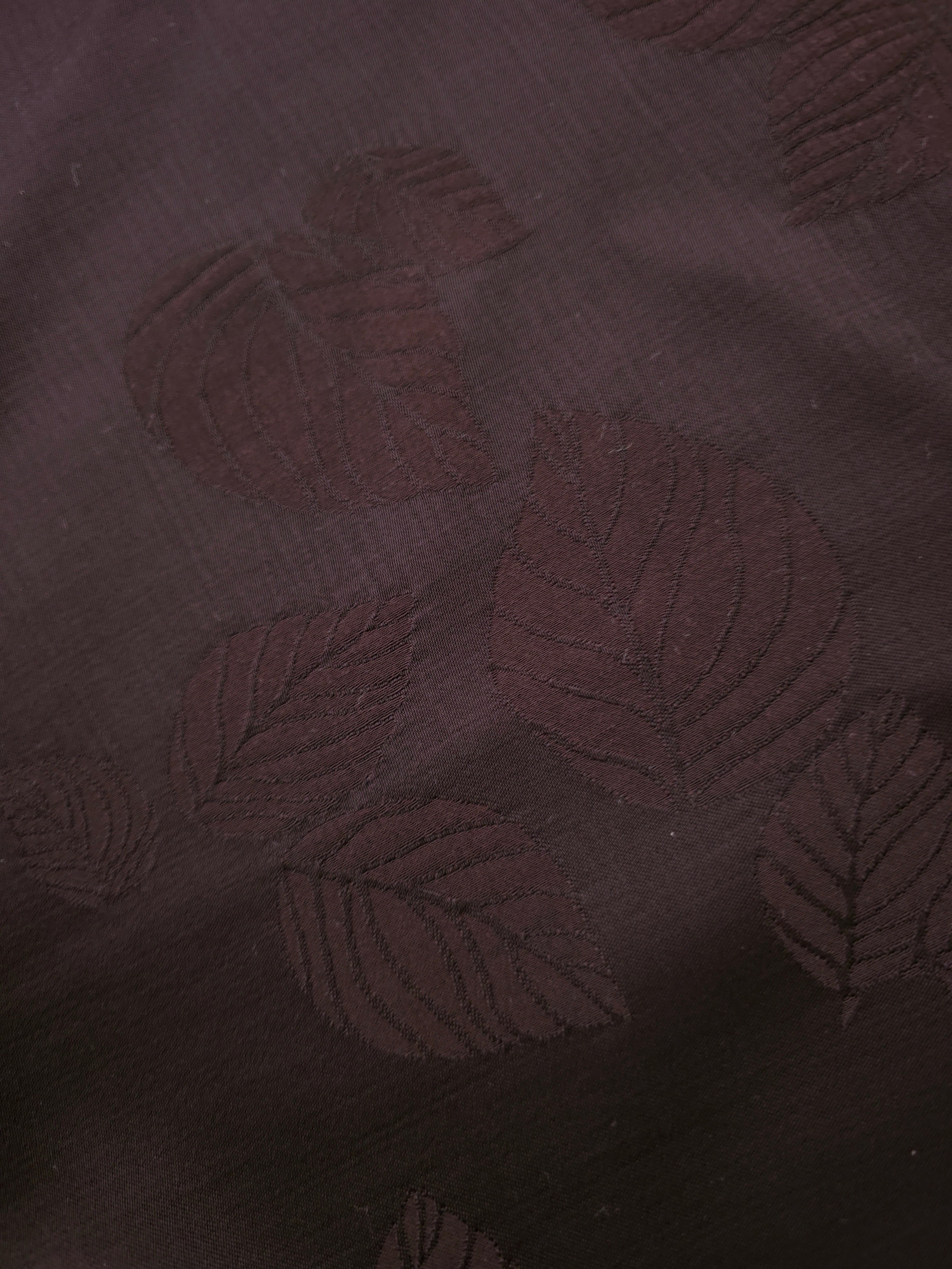 Close-up of warm beige botanical leaf print viscose fabric