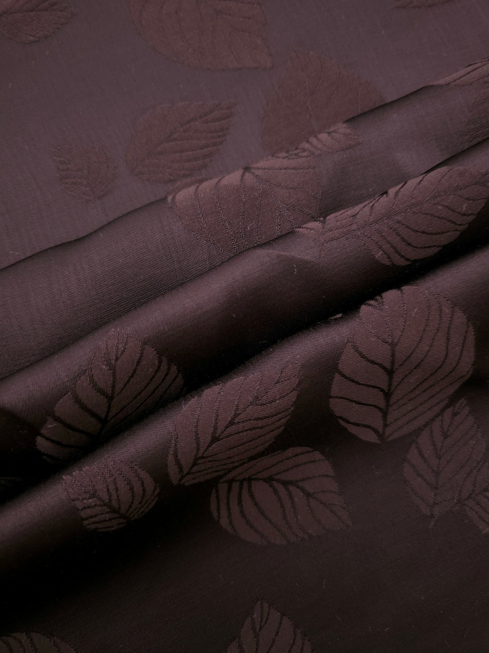 Warm beige botanical leaf print fabric detail showing organic motif
