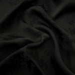 Black petal flower print viscose fabric with fluid garment drape