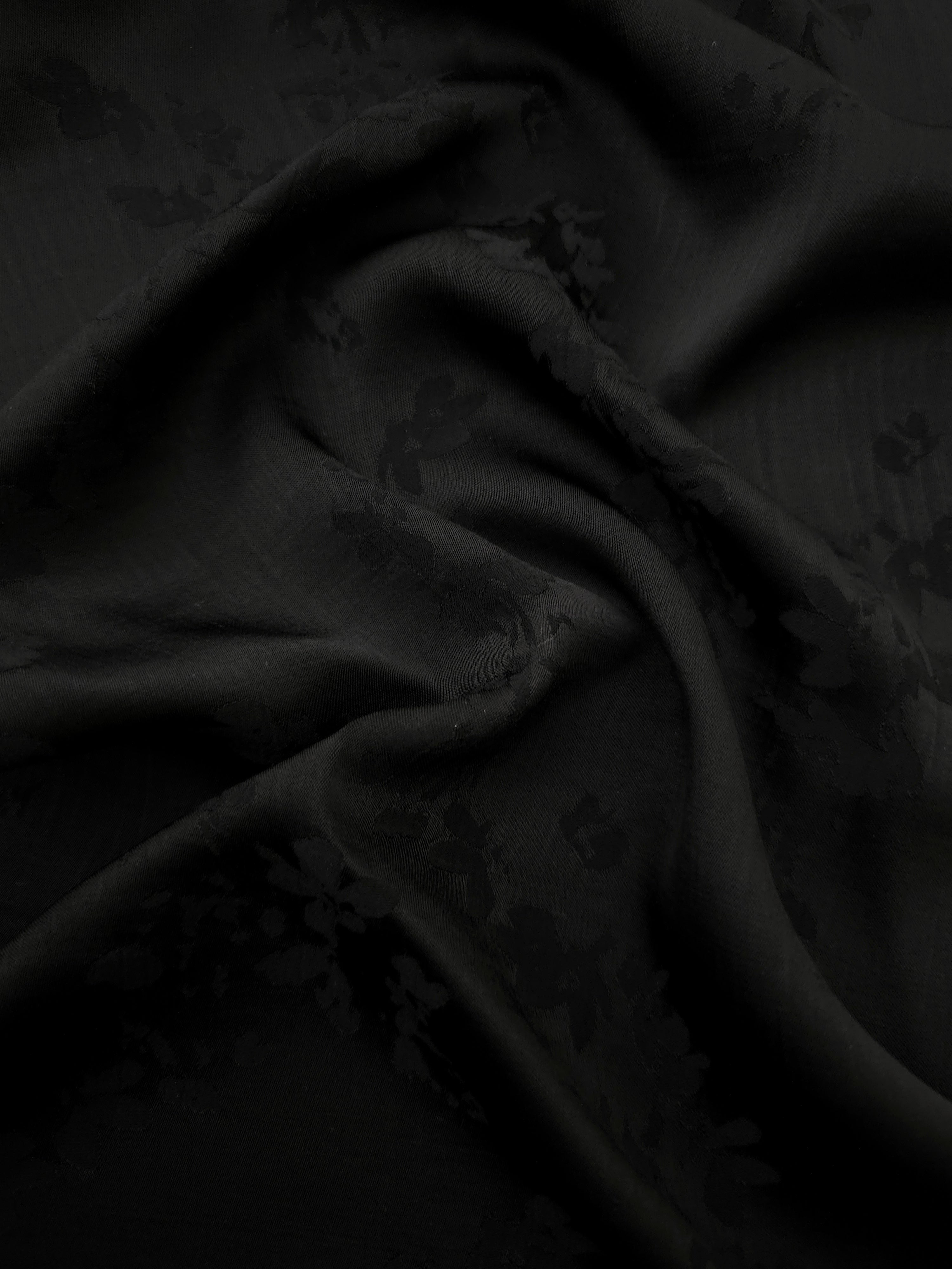 Black petal flower print viscose fabric with fluid garment drape