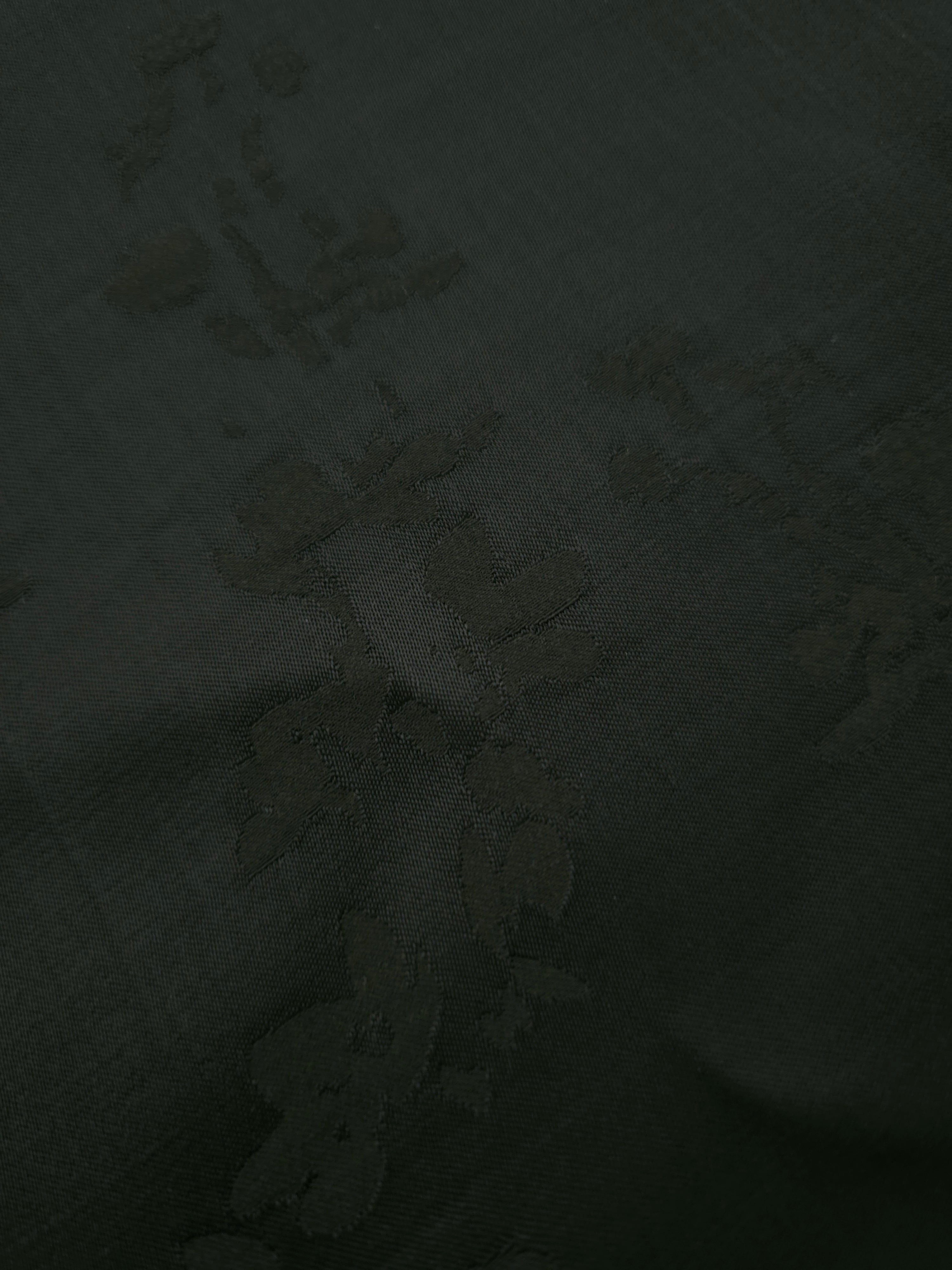 Close-up of dark green petal flower print viscose fabric