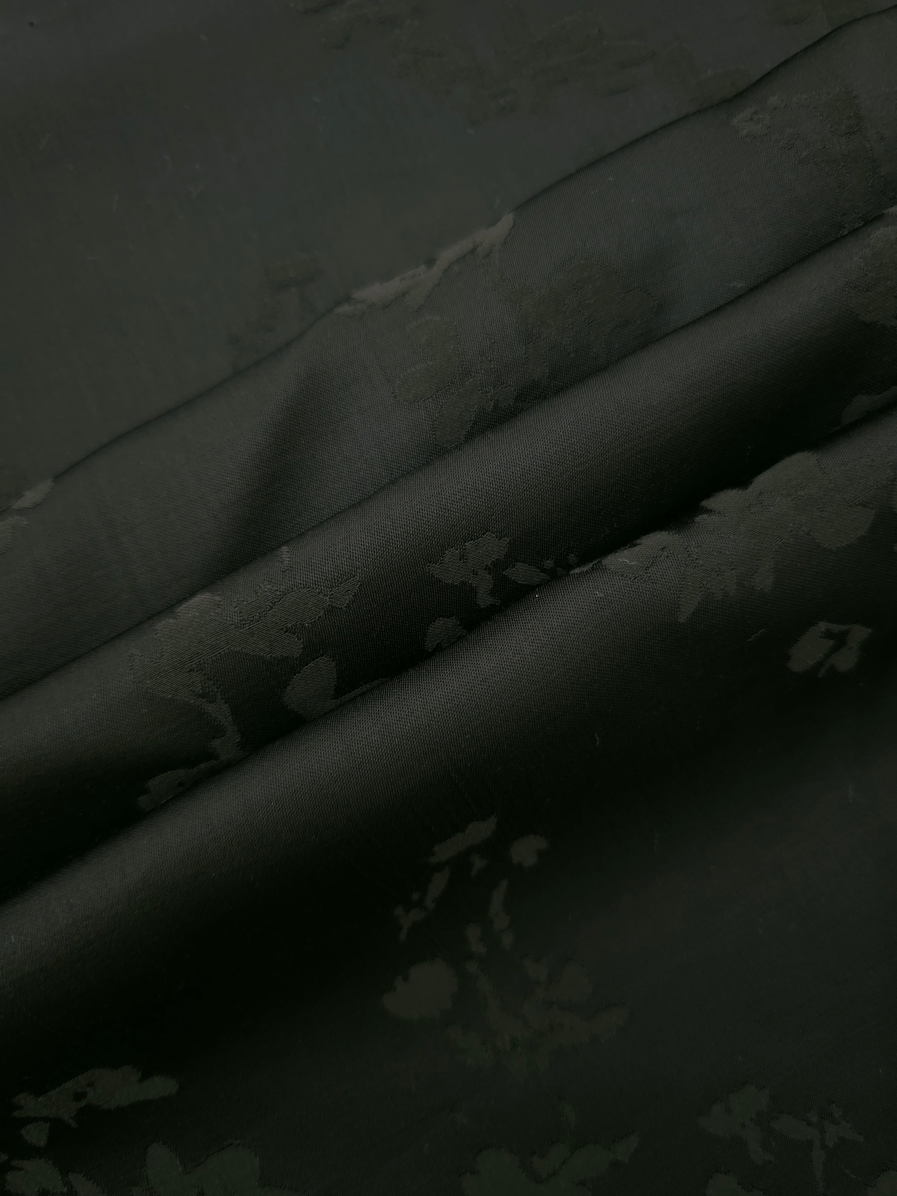 Dark green petal flower print fabric detail showing floral motif