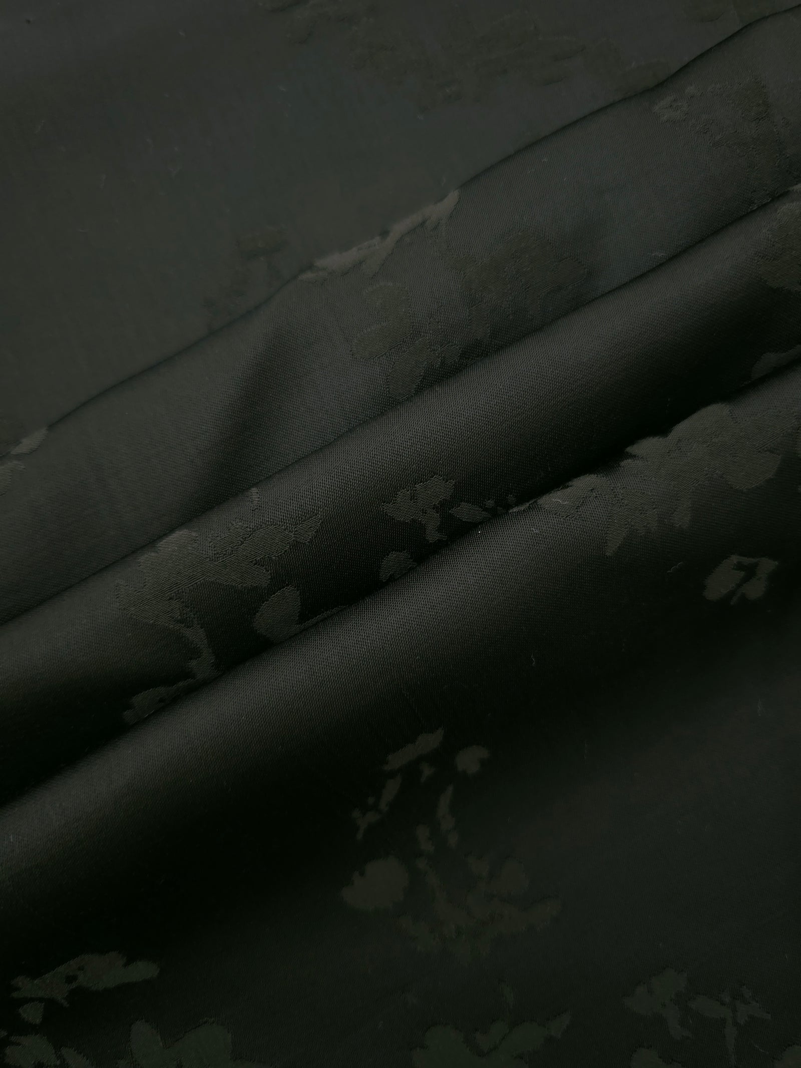 Dark green petal flower print fabric detail showing floral motif