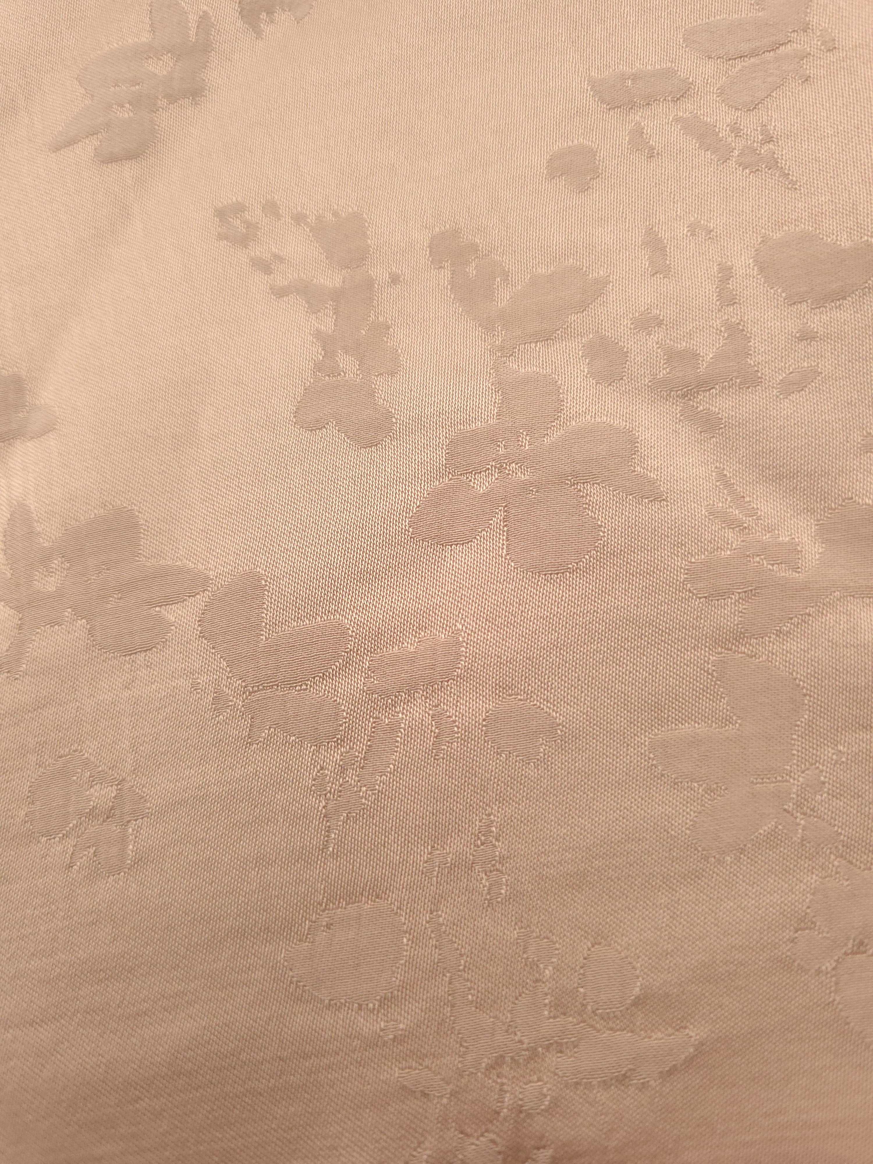 Close-up of warm beige petal flower print viscose fabric