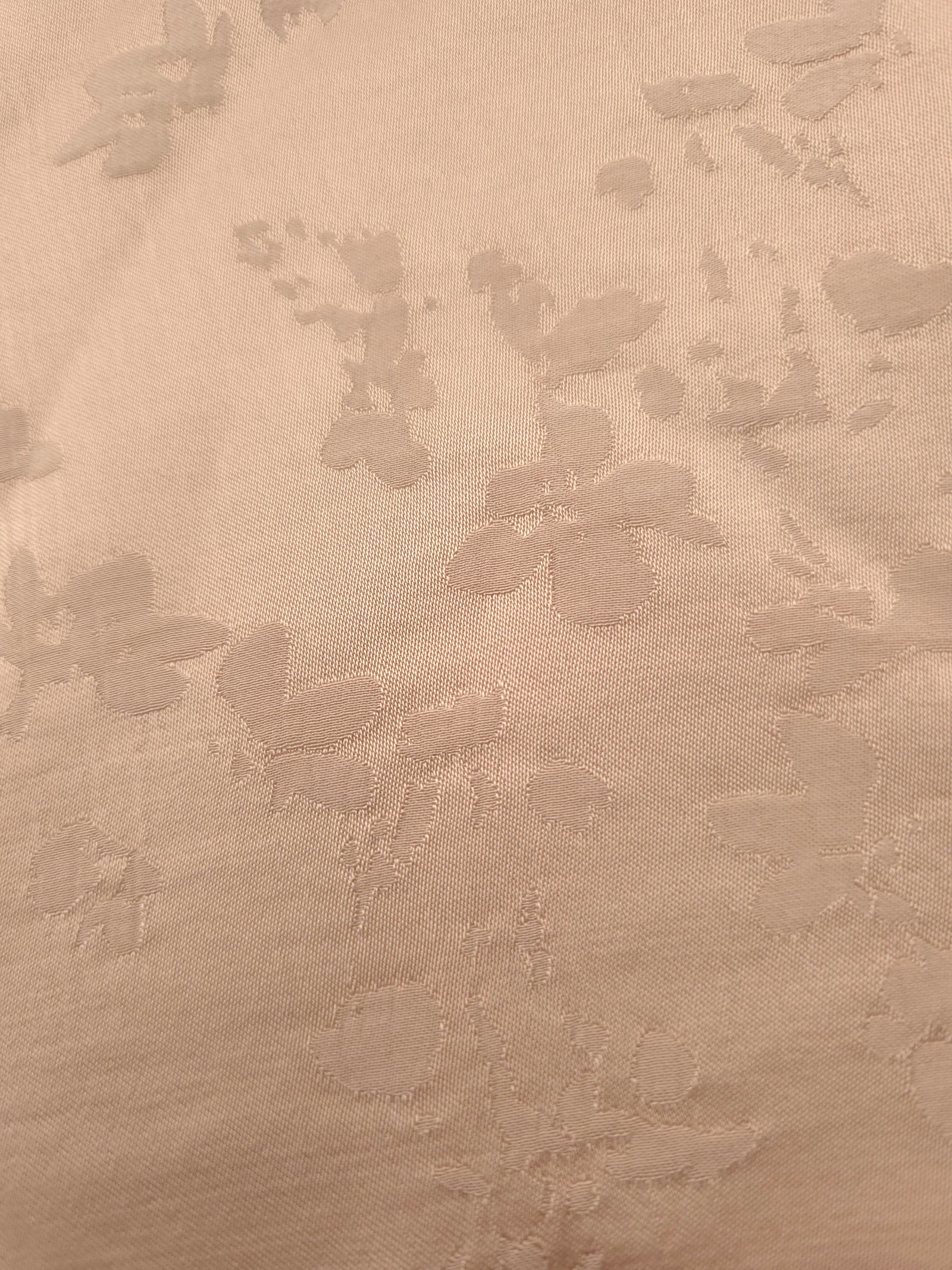 Close-up of warm beige petal flower print viscose fabric