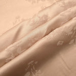 Warm beige petal flower print fabric detail showing floral motif