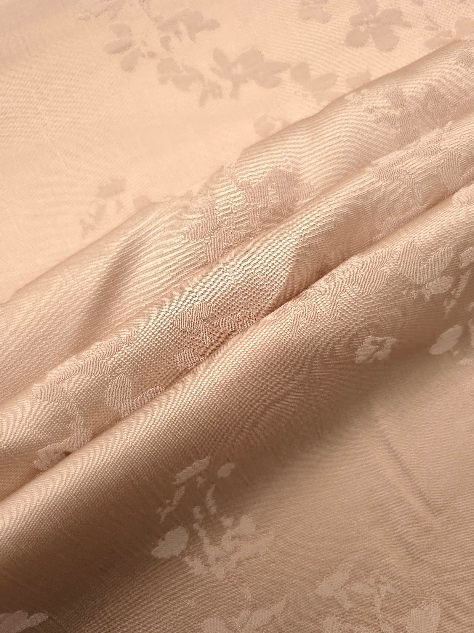 Warm beige petal flower print fabric detail showing floral motif