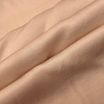Flowy warm beige plain viscose fabric showing soft fluid texture