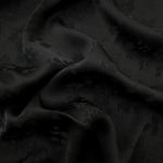 Black stylized leaf print viscose fabric with fluid garment drape