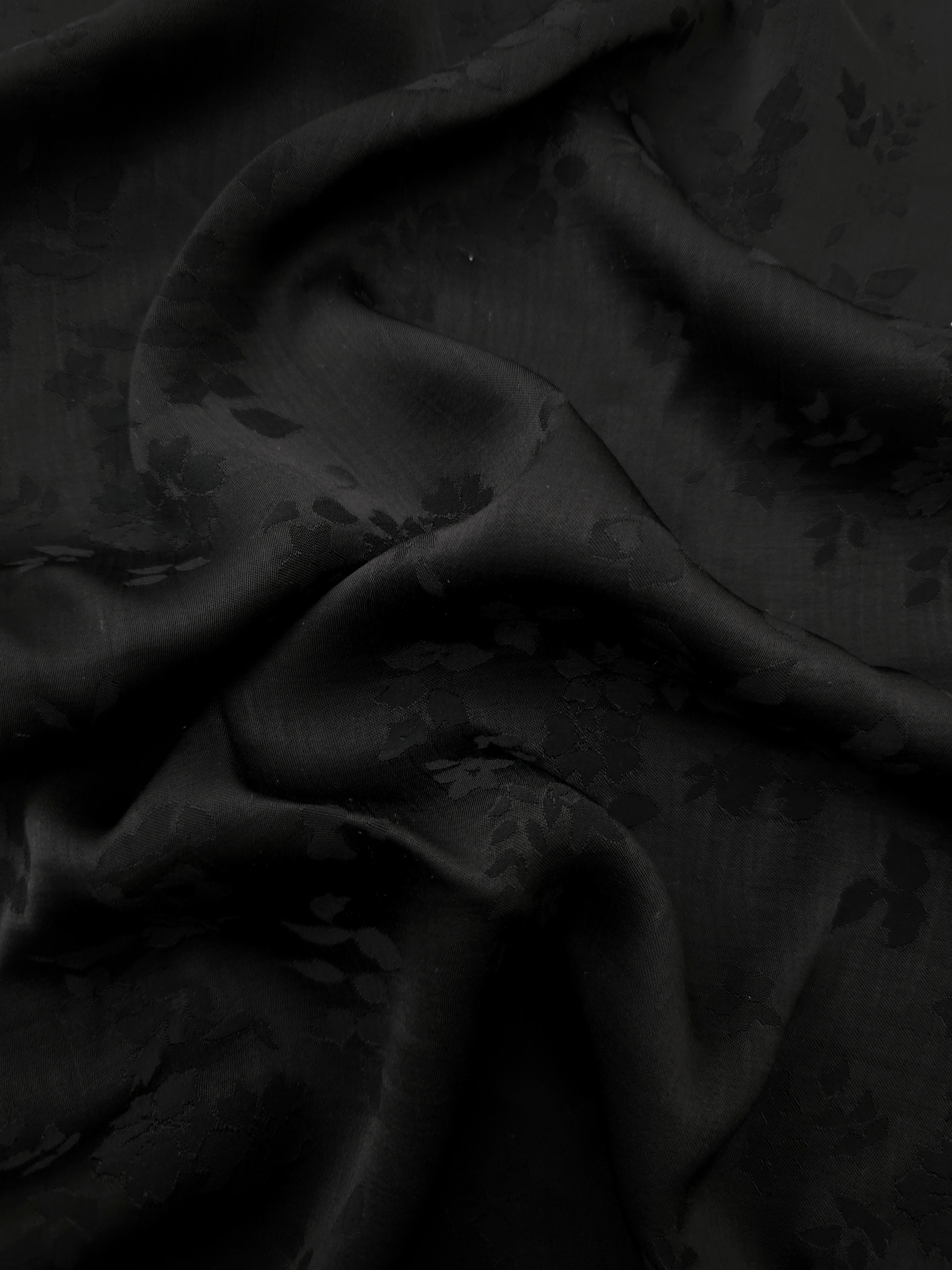 Black stylized leaf print viscose fabric with fluid garment drape