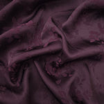 Cherry burgundy stylized leaf print viscose fabric with flowing drape