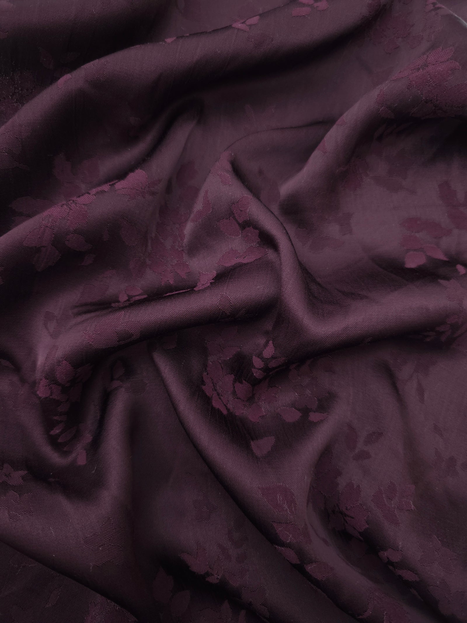 Cherry burgundy stylized leaf print viscose fabric with flowing drape