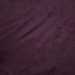 Close-up of cherry burgundy stylized leaf print viscose fabric