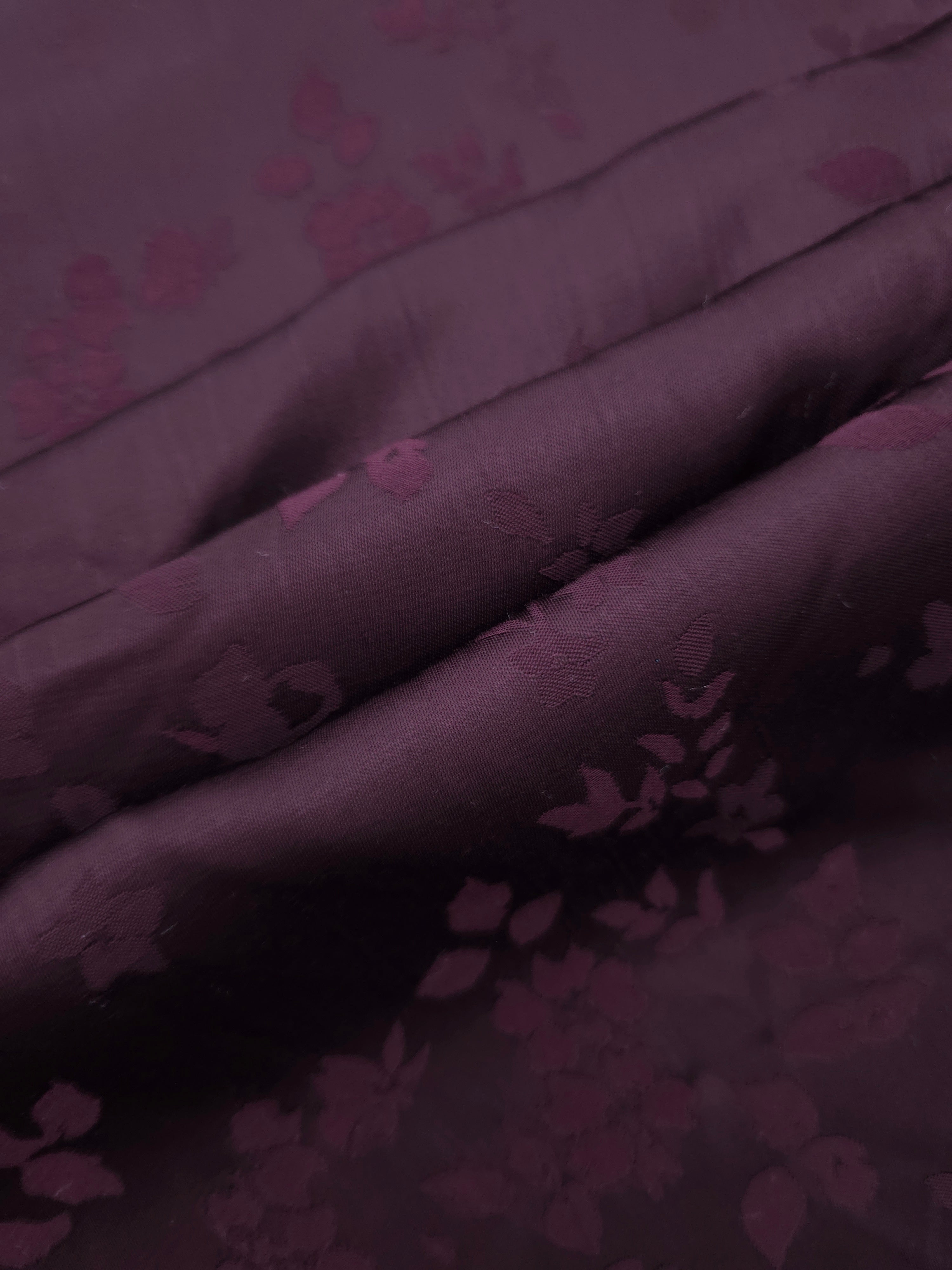 Cherry burgundy stylized leaf print fabric detail showing modern motif