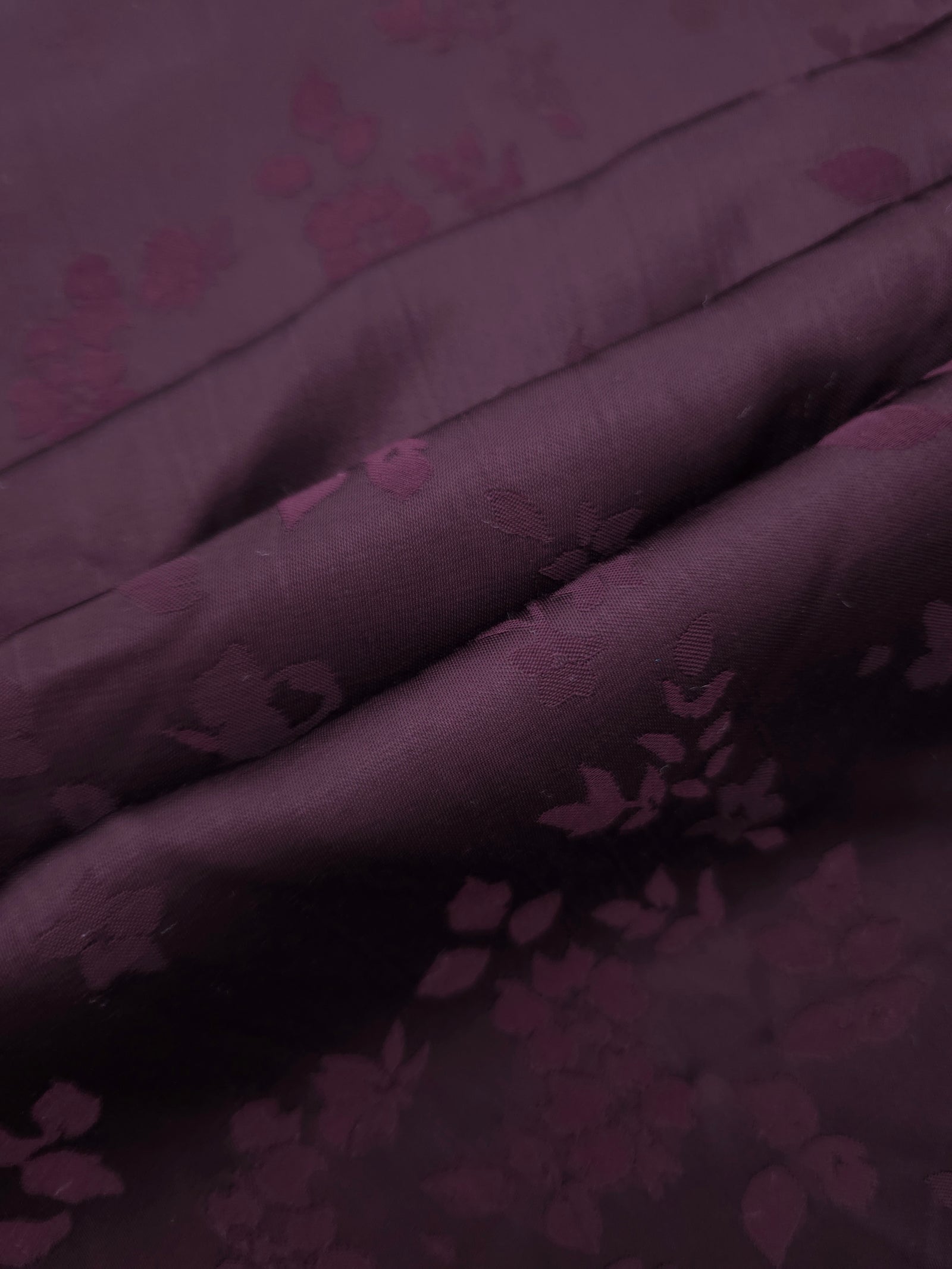 Cherry burgundy stylized leaf print fabric detail showing modern motif