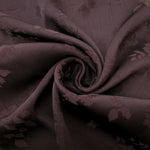 Close-up of warm beige stylized leaf print viscose fabric