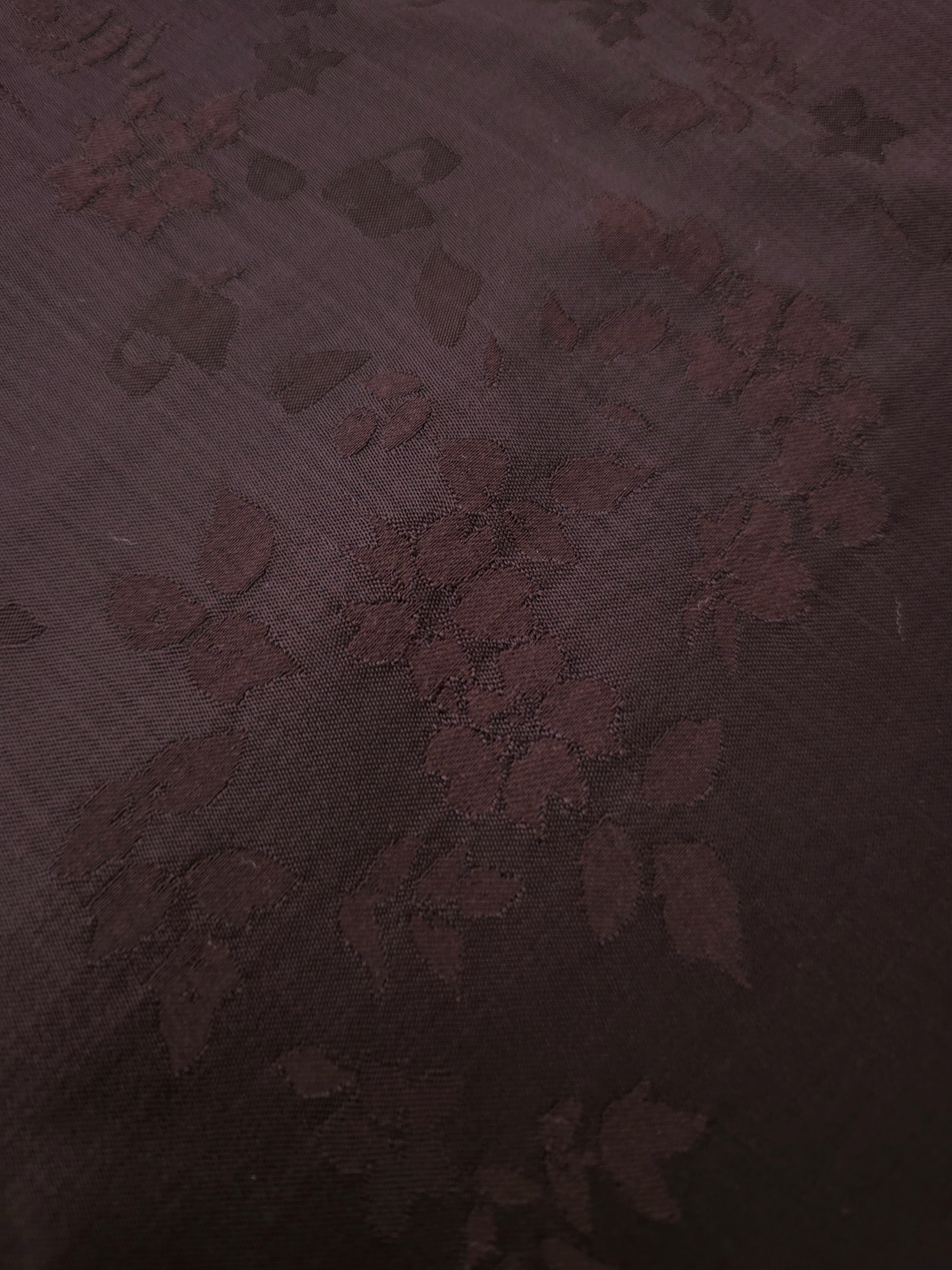 Warm beige stylized leaf print fabric detail showing modern motif