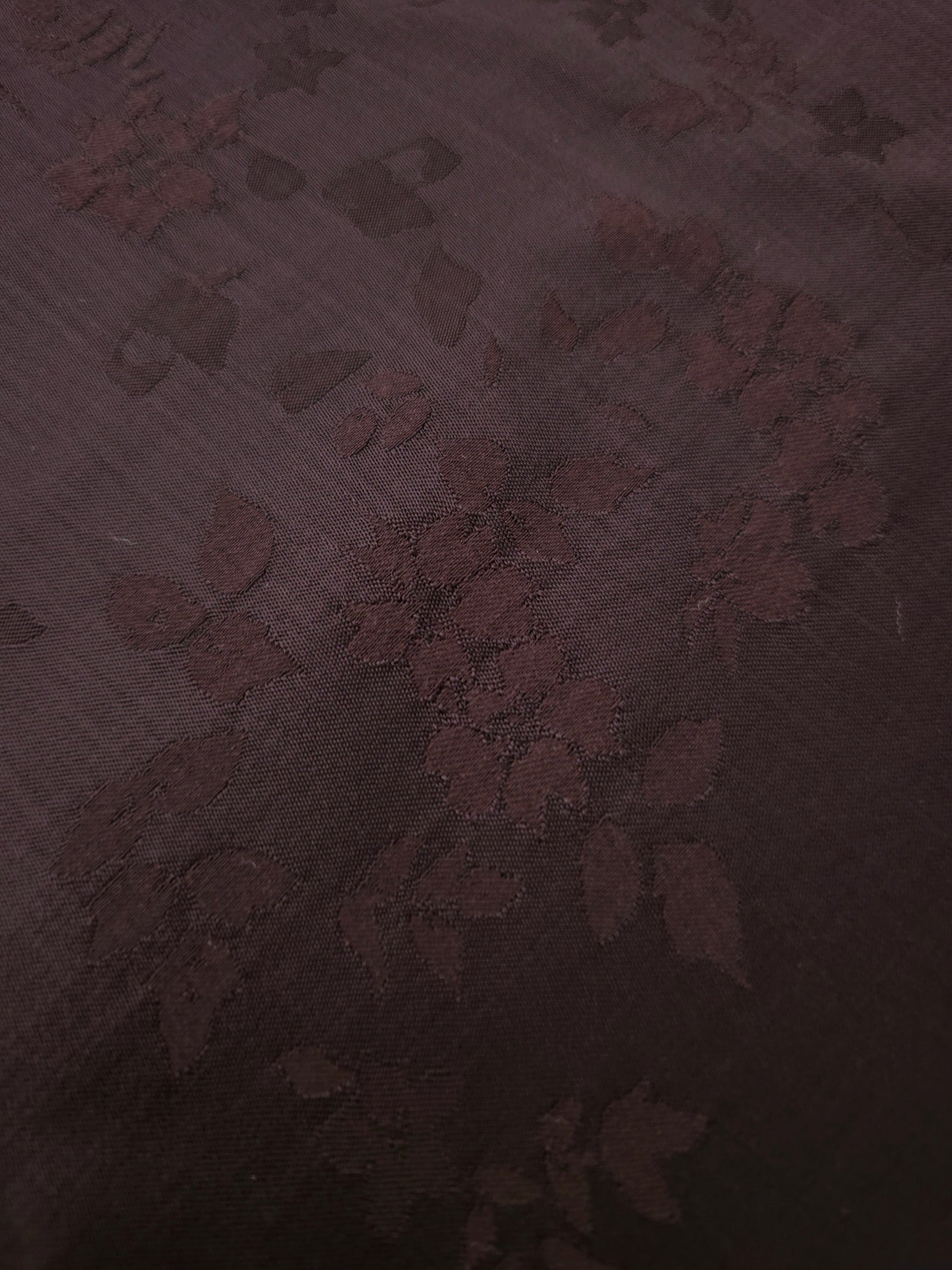Warm beige stylized leaf print fabric detail showing modern motif