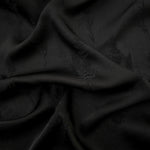 Black wild tree botanical print viscose fabric with fluid garment drape