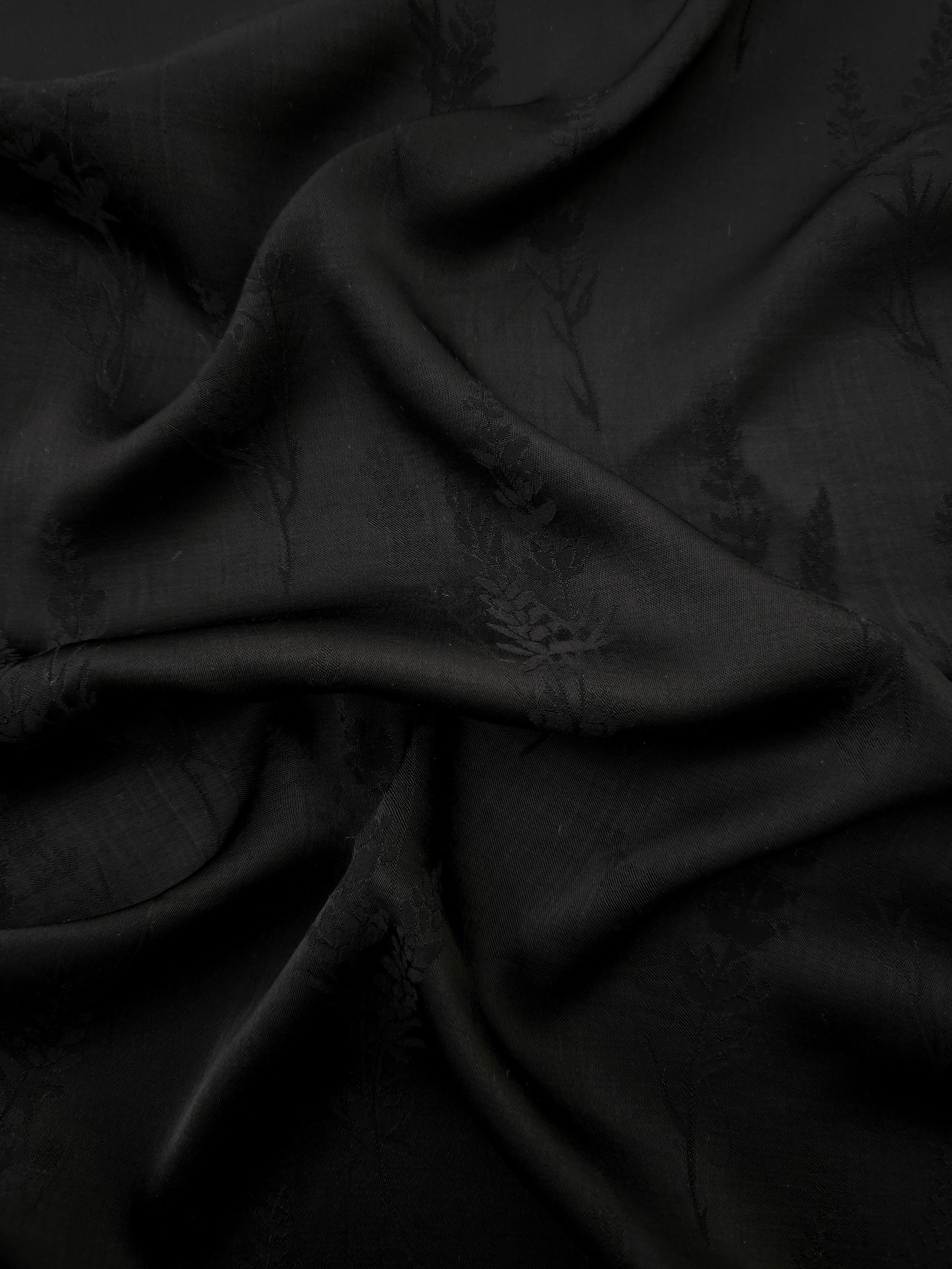 Black wild tree botanical print viscose fabric with fluid garment drape