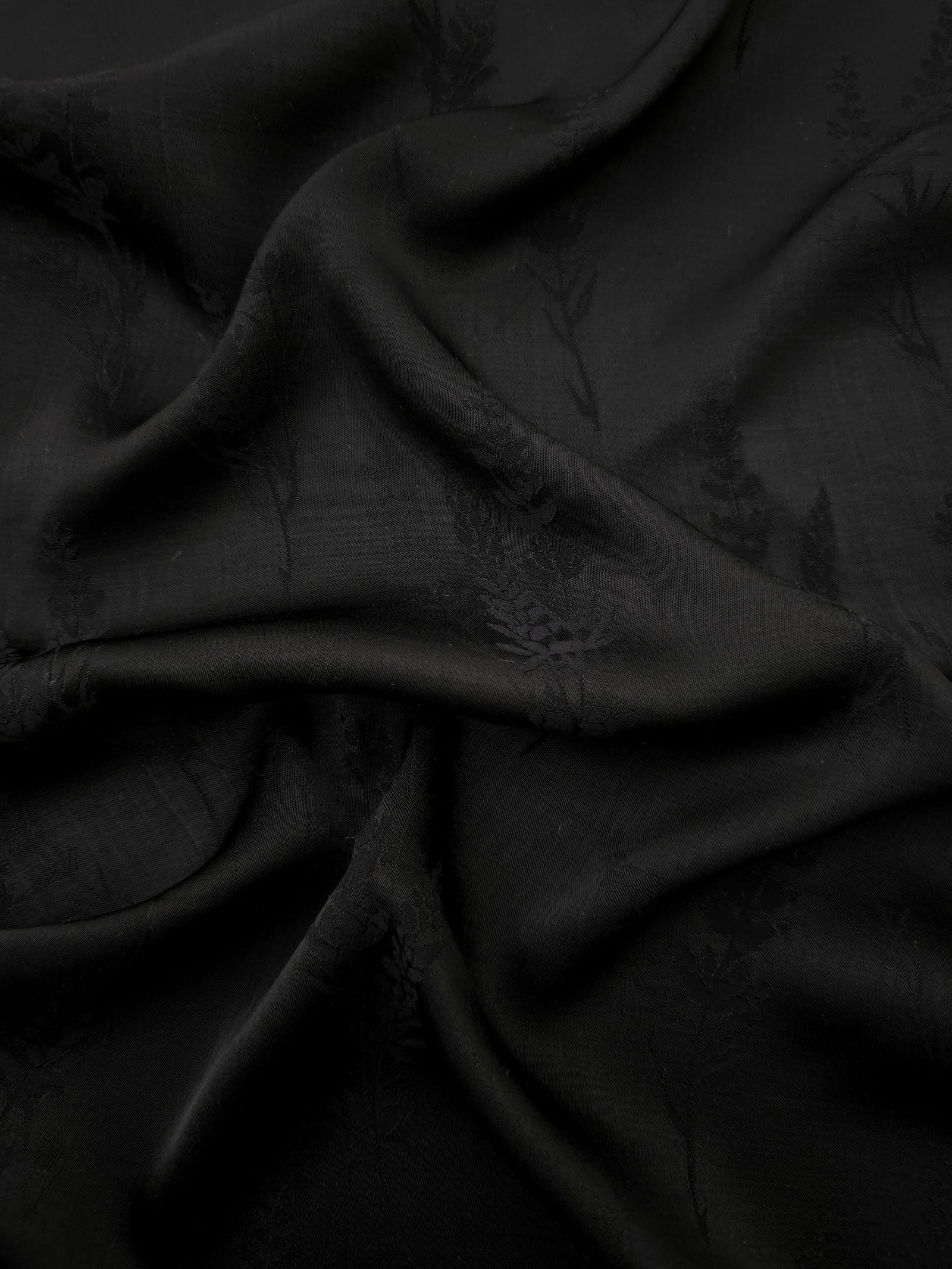 Black wild tree botanical print viscose fabric with fluid garment drape