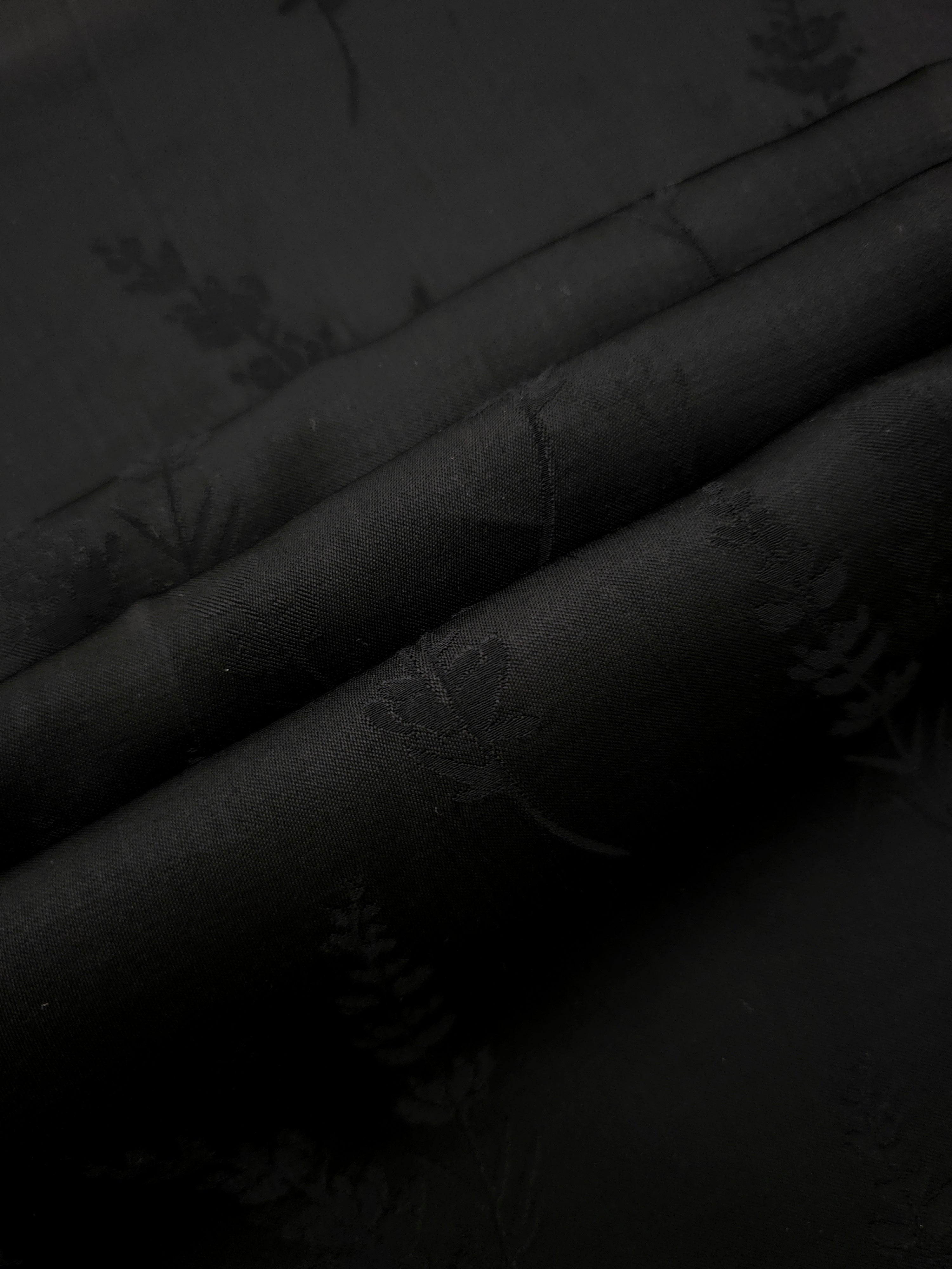 Detailed black wild tree print viscose fabric showing botanical motif