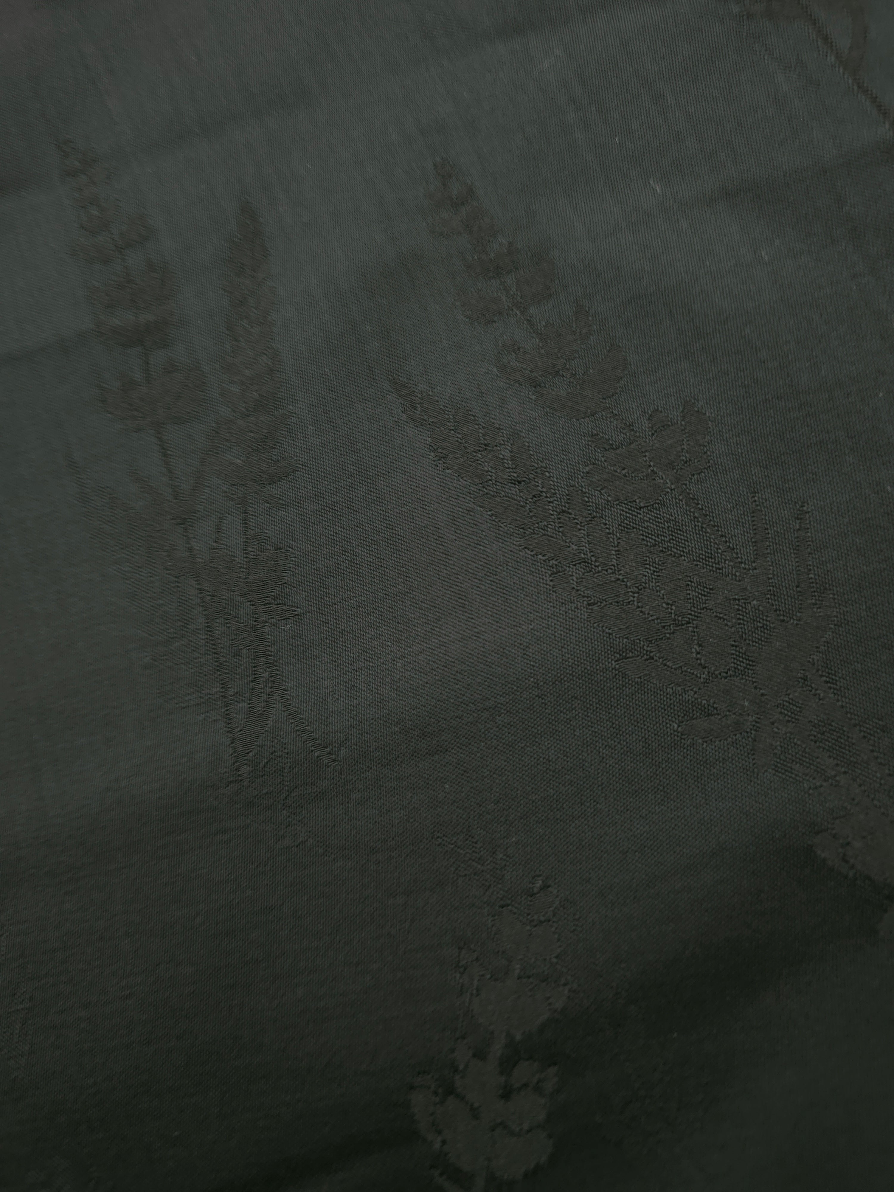 Close-up of dark green wild tree botanical print viscose fabric