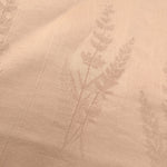 Close-up of warm beige wild tree botanical print viscose fabric