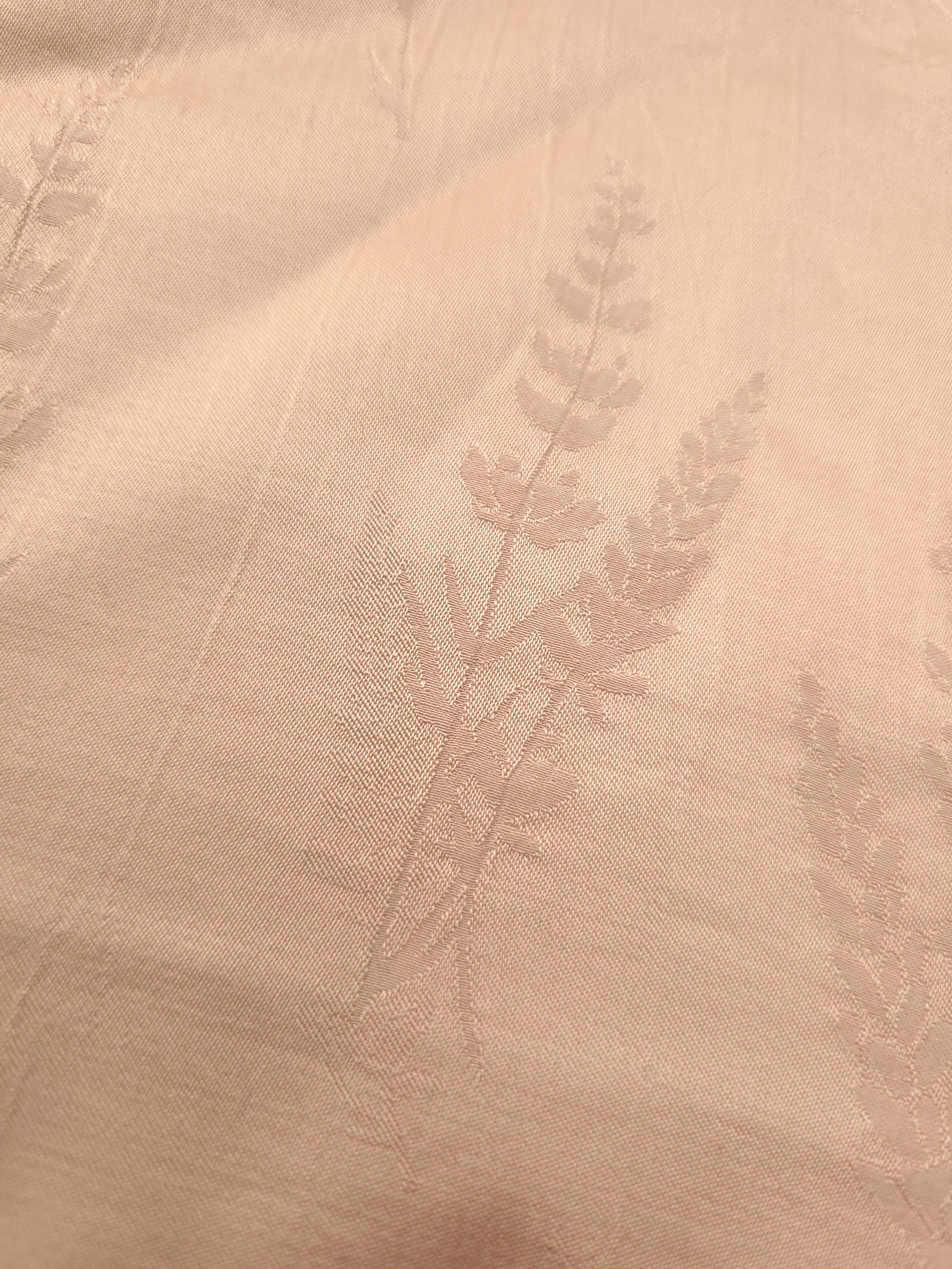 Close-up of warm beige wild tree botanical print viscose fabric