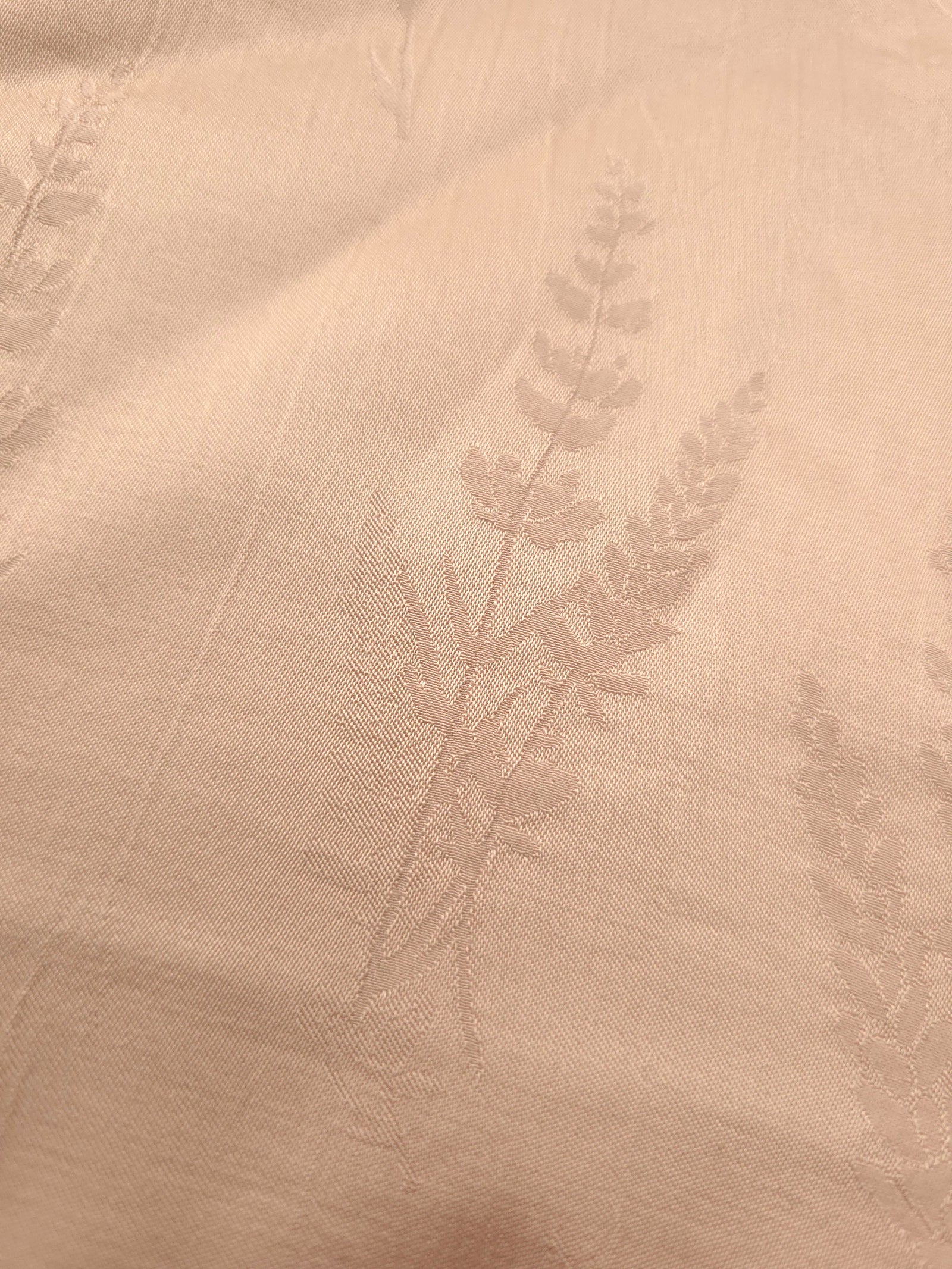 Close-up of warm beige wild tree botanical print viscose fabric