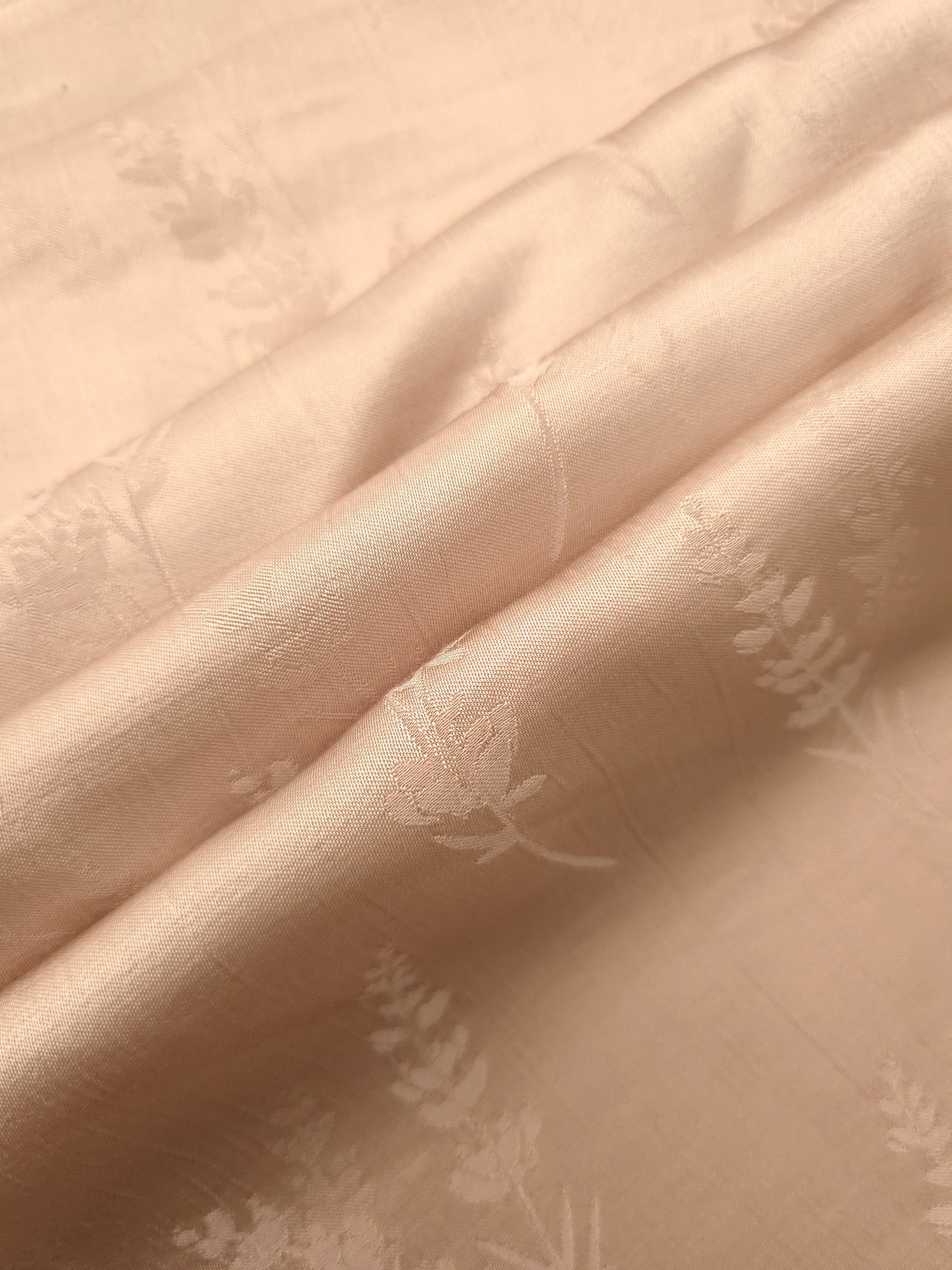 Warm beige wild tree print fabric detail showing botanical pattern