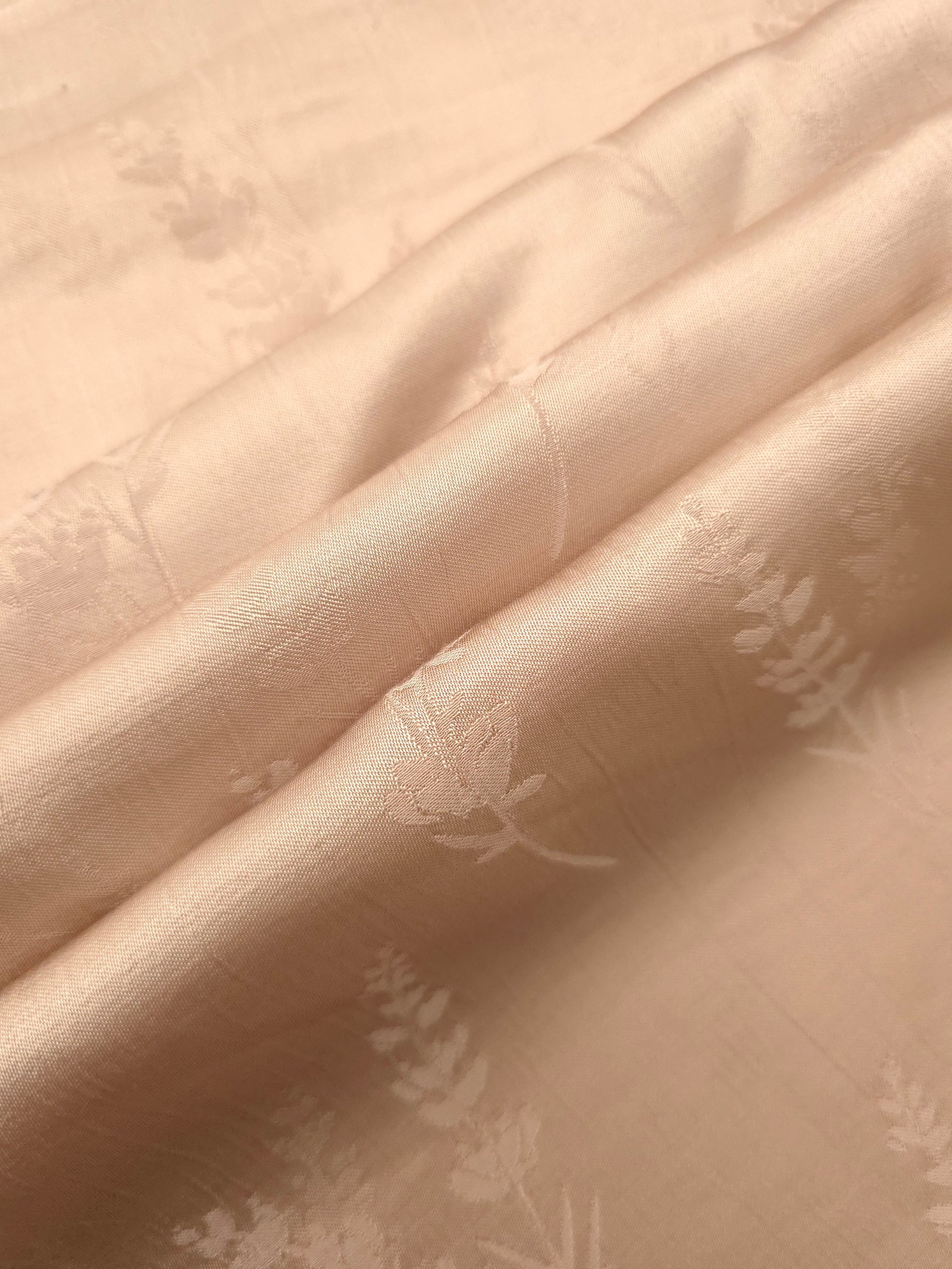Warm beige wild tree print fabric detail showing botanical pattern