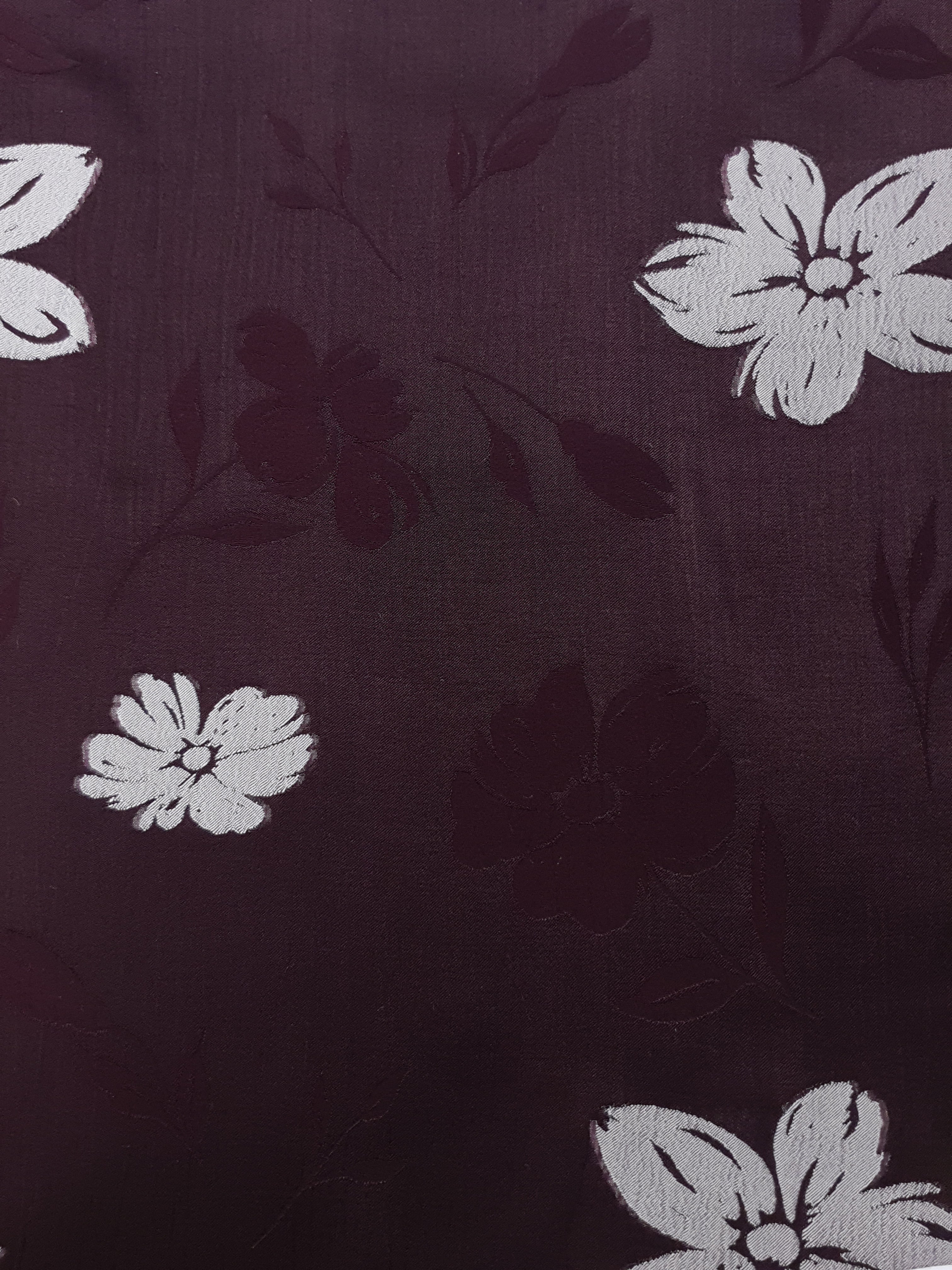 Close view of viscose embossed two-tone jacquard with raised texture for dresses.