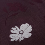 Texture detail of two-tone viscose jacquard showing embossed woven surface.