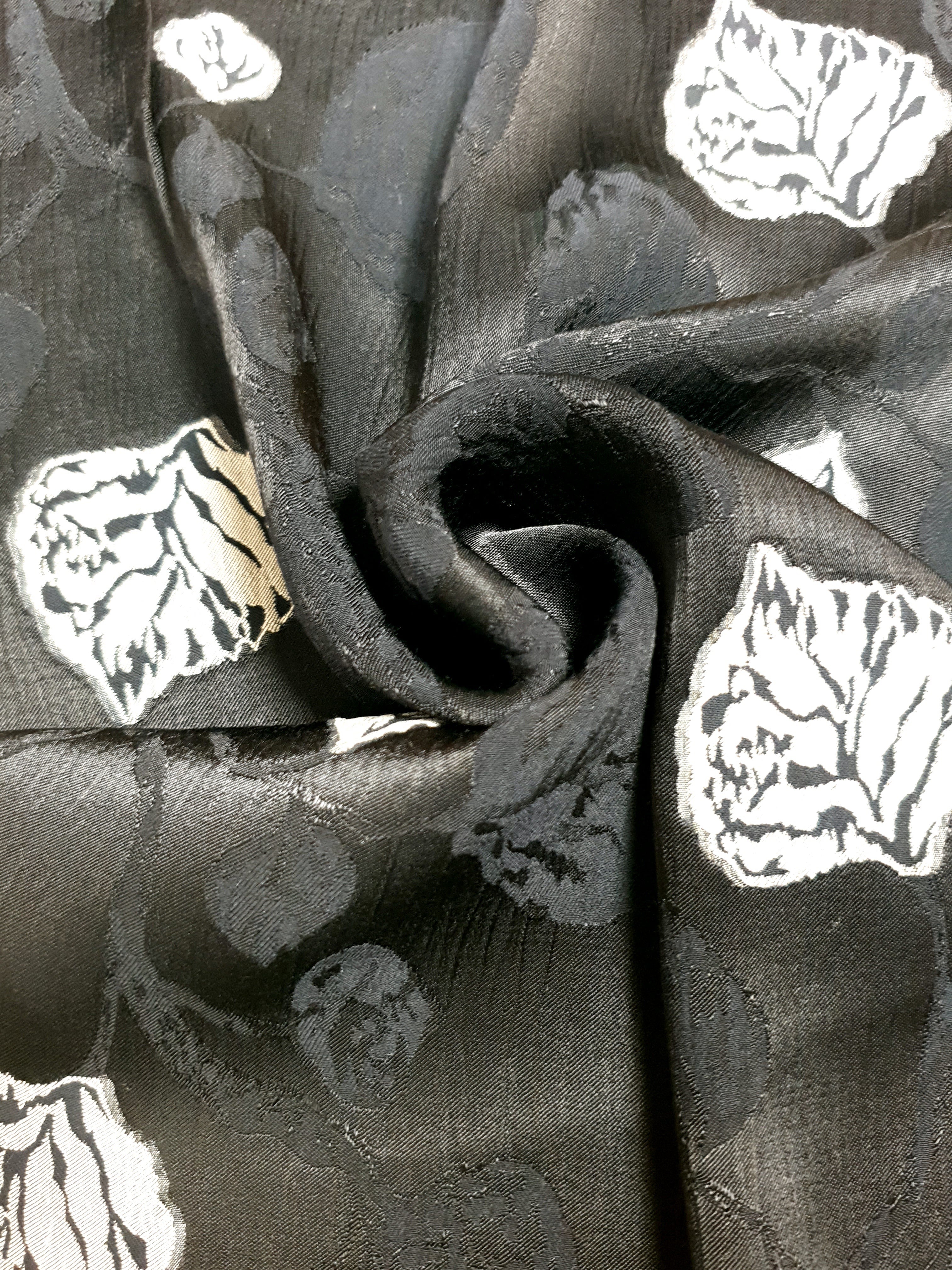 Drape shot of viscose embossed jacquard with structured flow for dresses.