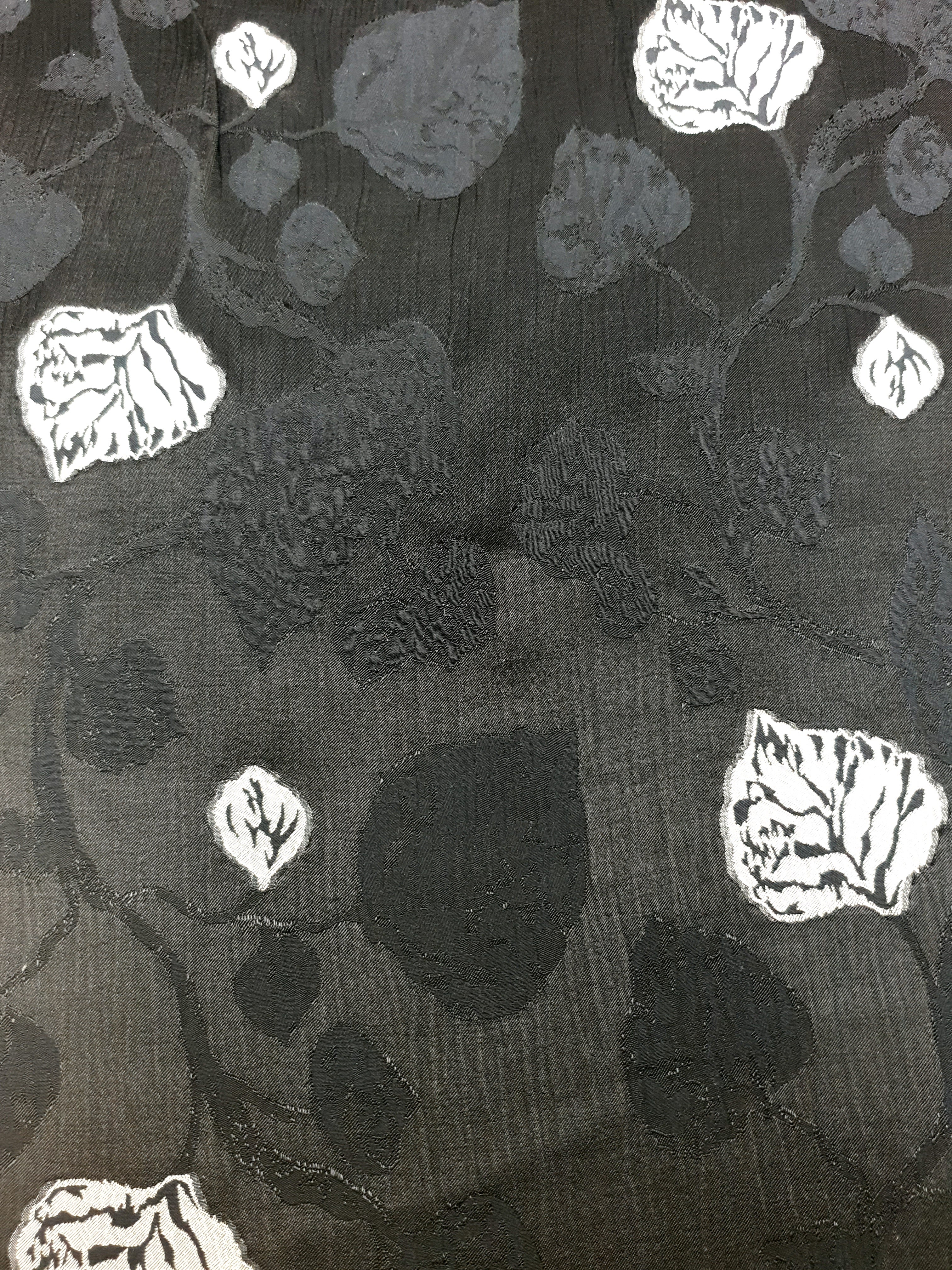 Draped rayon viscose jacquard showing fluid movement and raised pattern.