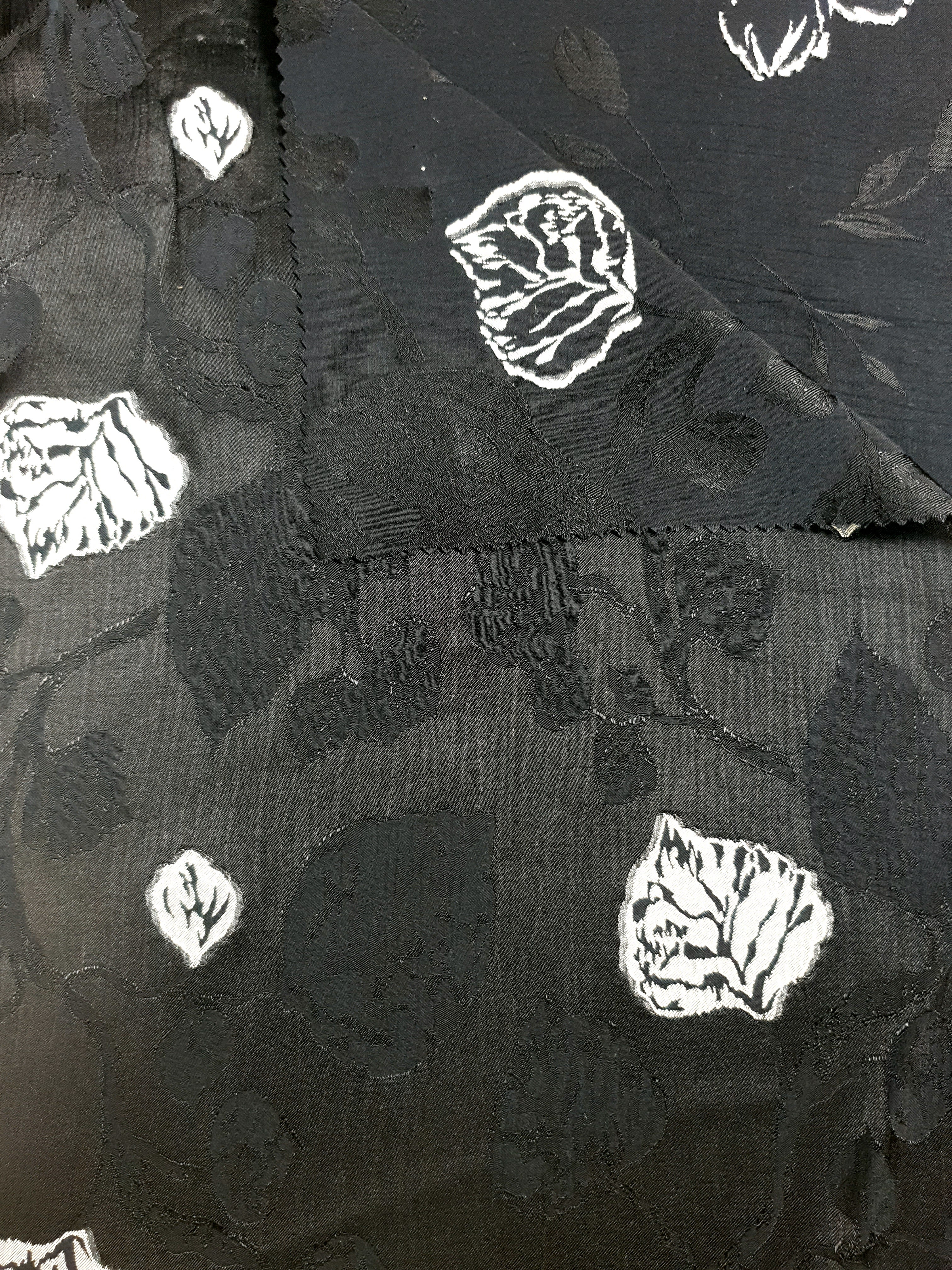 Two-tone jacquard close-up for dresses, overlays and boutique sewing.