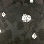 Detail view of soft embossed jacquard fabric with raised woven finish.