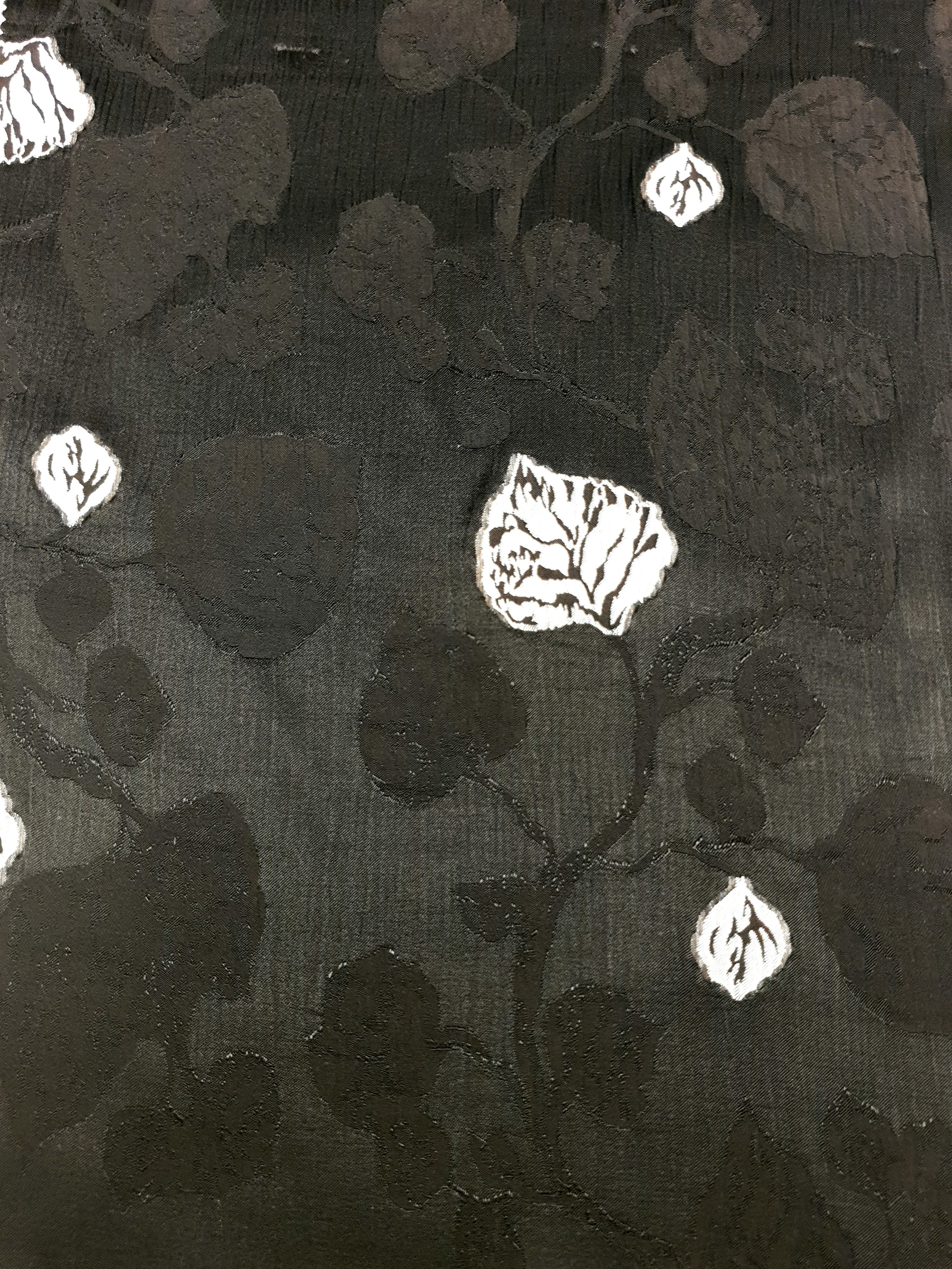 Detail view of soft embossed jacquard fabric with raised woven finish.