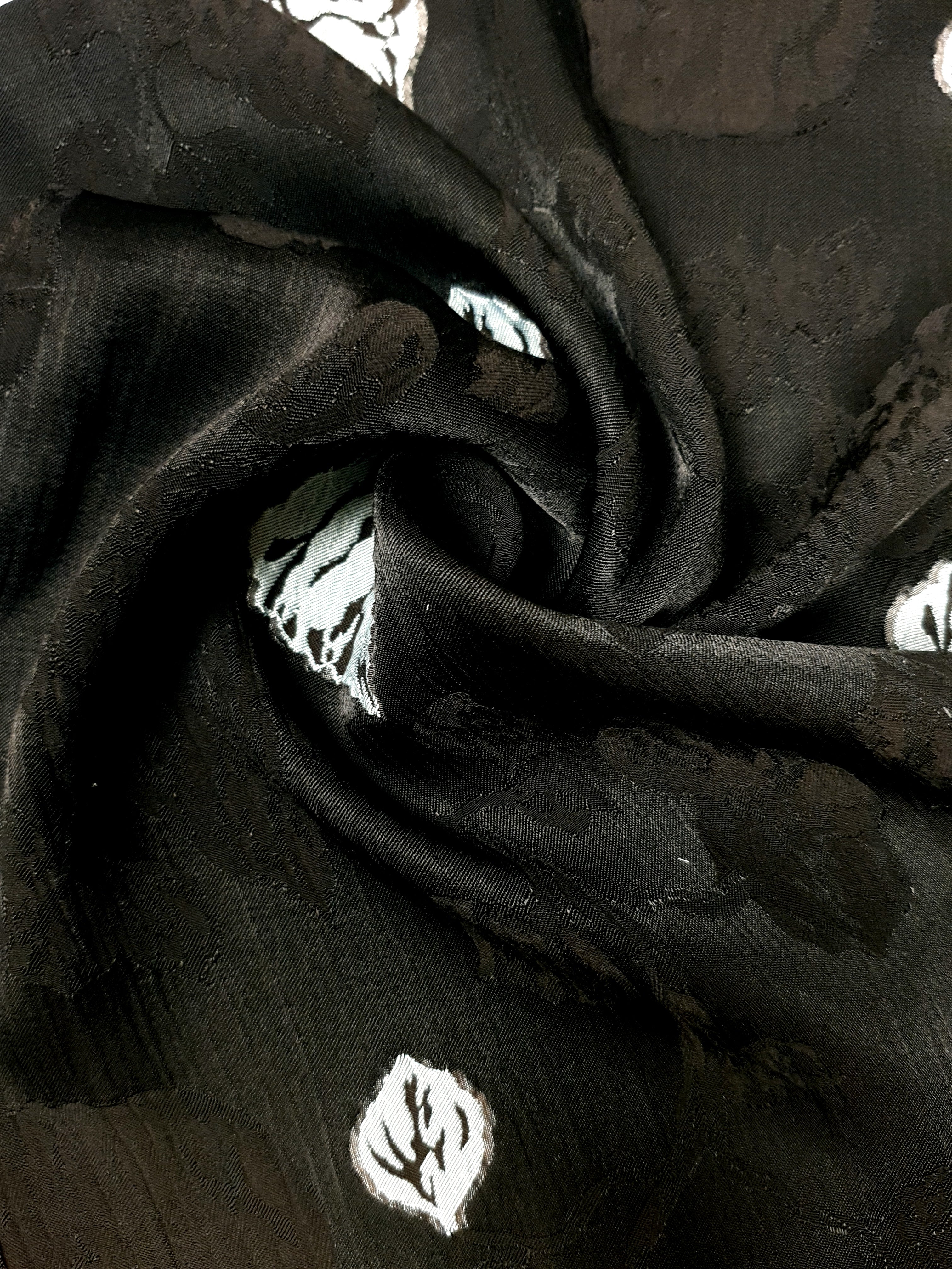 Close drape of two-tone viscose jacquard showing soft woven texture.